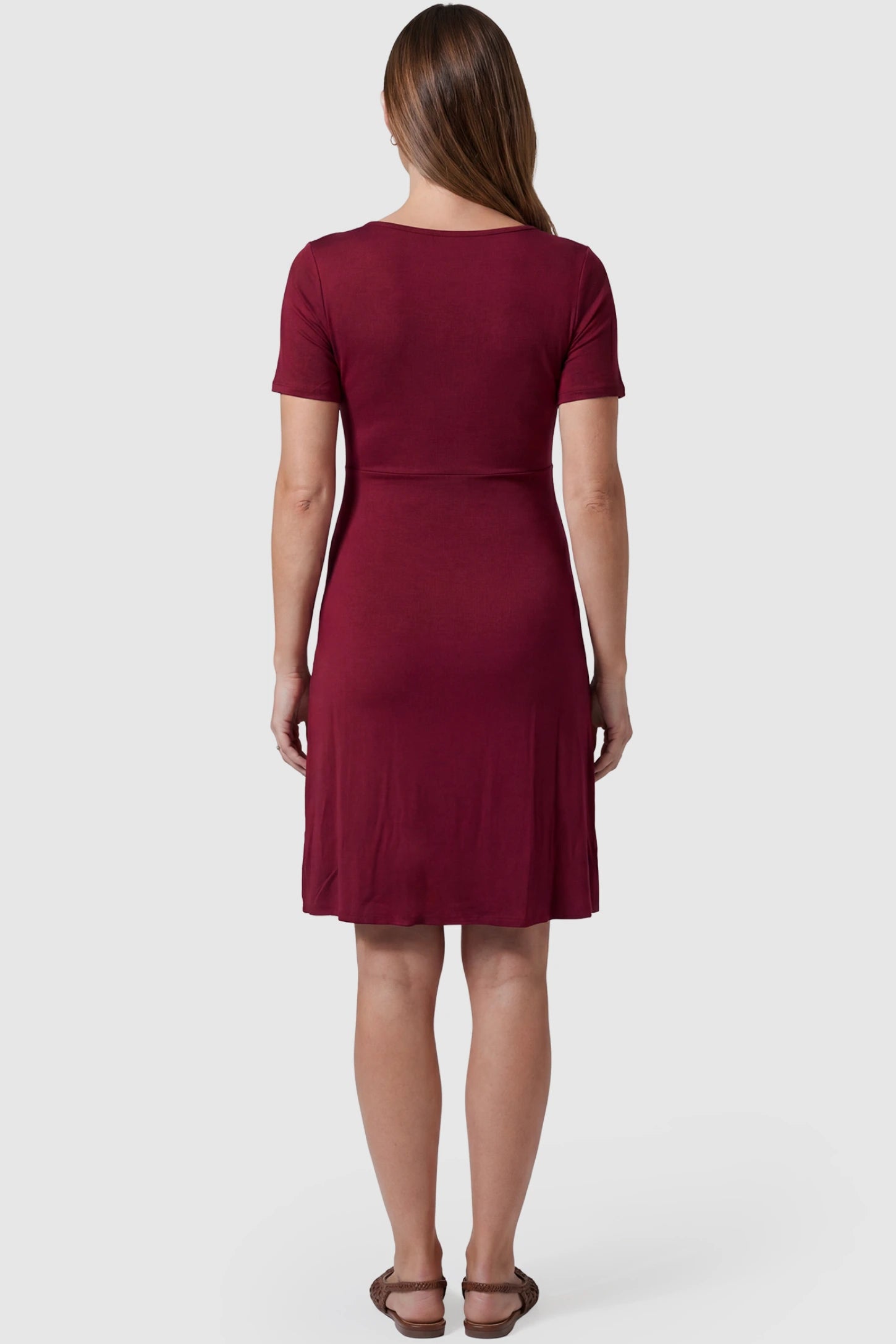 Drawstring Bow Front A‑Line Maternity Short Dress Drawstring bow front A-line maternity short dress in wine red with flowy A-line silhouette, back view on pregnant model