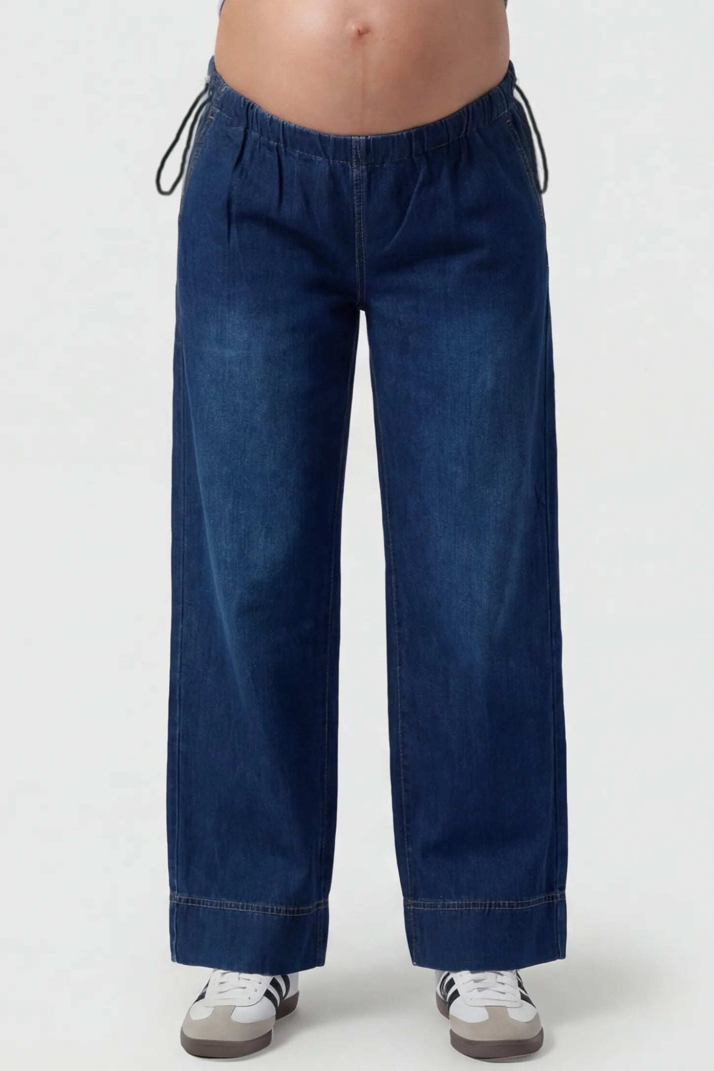 Drawstring Wide-Leg Maternity Jeans Drawstring Wide-Leg Maternity Jeans in dark blue featuring adjustable waist and relaxed full-length silhouette on pregnant model front view.