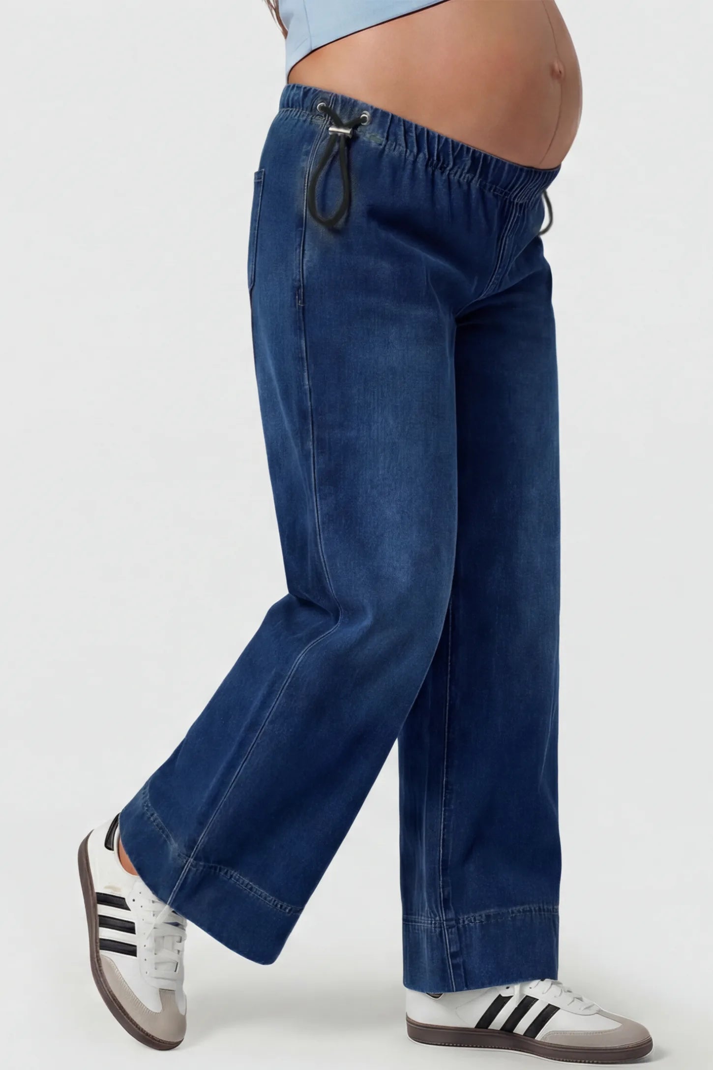 Drawstring Wide-Leg Maternity Jeans Drawstring Wide-Leg Maternity Jeans in dark blue featuring adjustable waist and relaxed full-length silhouette on pregnant model side view.