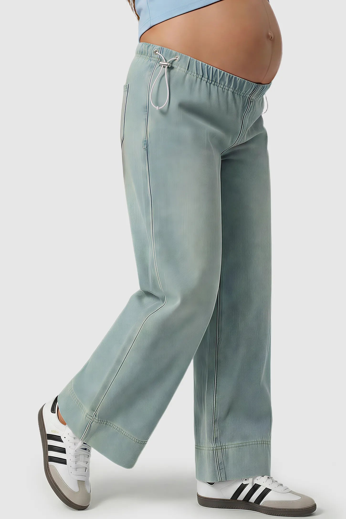 Drawstring Wide-Leg Maternity Jeans Drawstring Wide-Leg Maternity Jeans in light blue featuring adjustable waist and relaxed full-length silhouette on pregnant model side view.