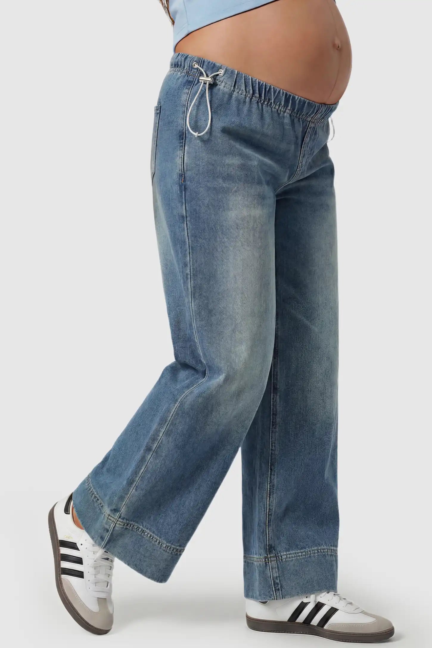 Drawstring Wide-Leg Maternity Jeans Drawstring Wide-Leg Maternity Jeans in vintage blue featuring adjustable waist and relaxed full-length silhouette on pregnant model side view.