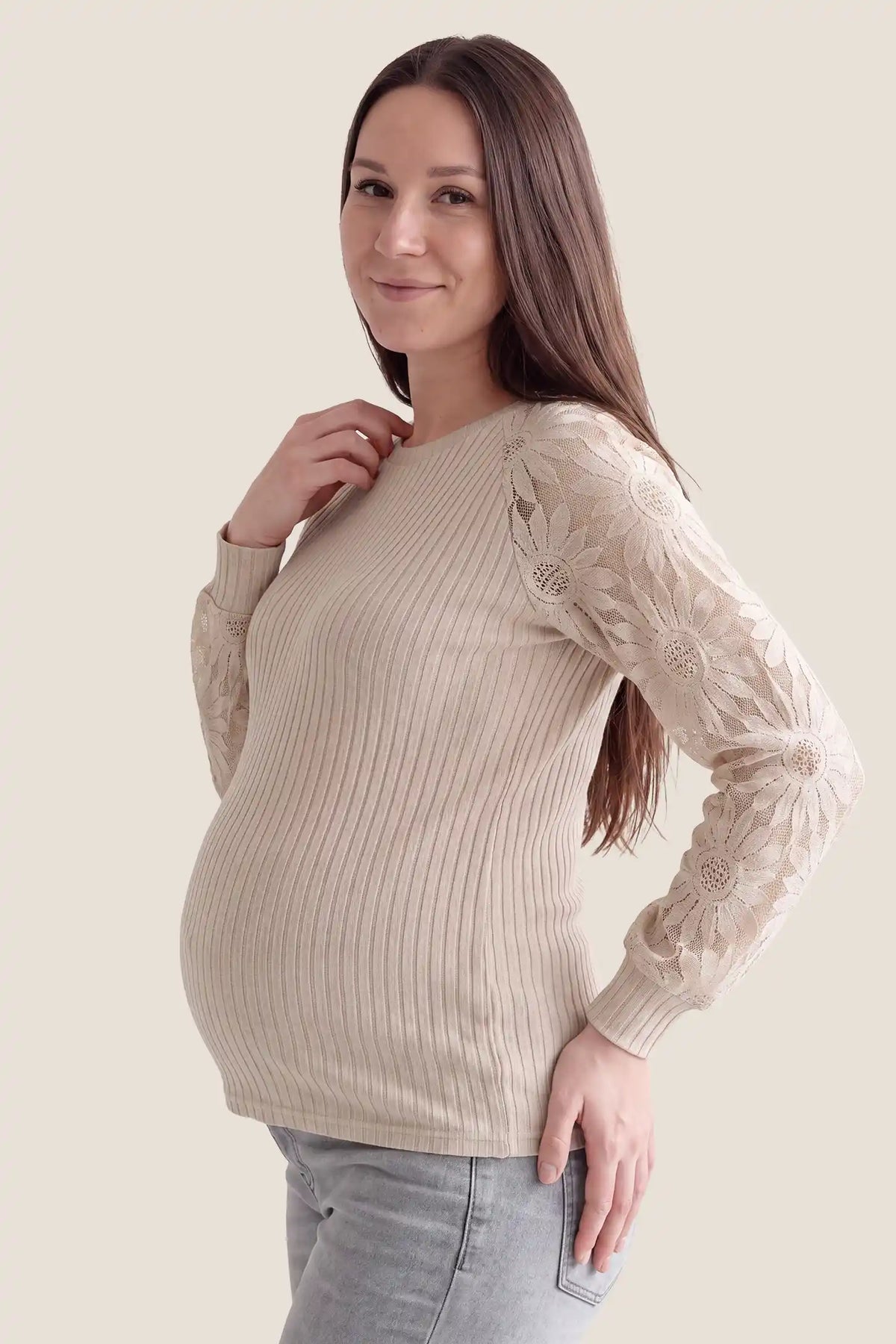 Elegant Openwork Crew Neck Long Sleeve Top Elegant Openwork Crew Neck Long Sleeve Top in Beige featuring accommodating belly stretch design, soft openwork knit fabric, and gentle bump support on a pregnant model, side profile view.