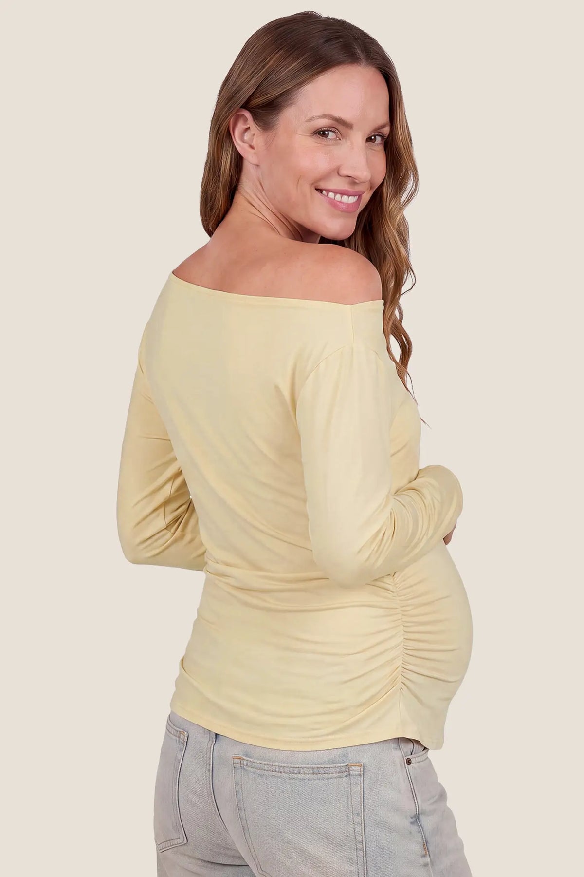 Elegant Ruched Side Off-Shoulder Maternity Top Elegant Ruched Side Off-Shoulder Maternity Top in Butter Yellow featuring smooth off-the-shoulder back cut, soft lightweight fabric feel, and comfortable maternity fit on a pregnant model, back view.