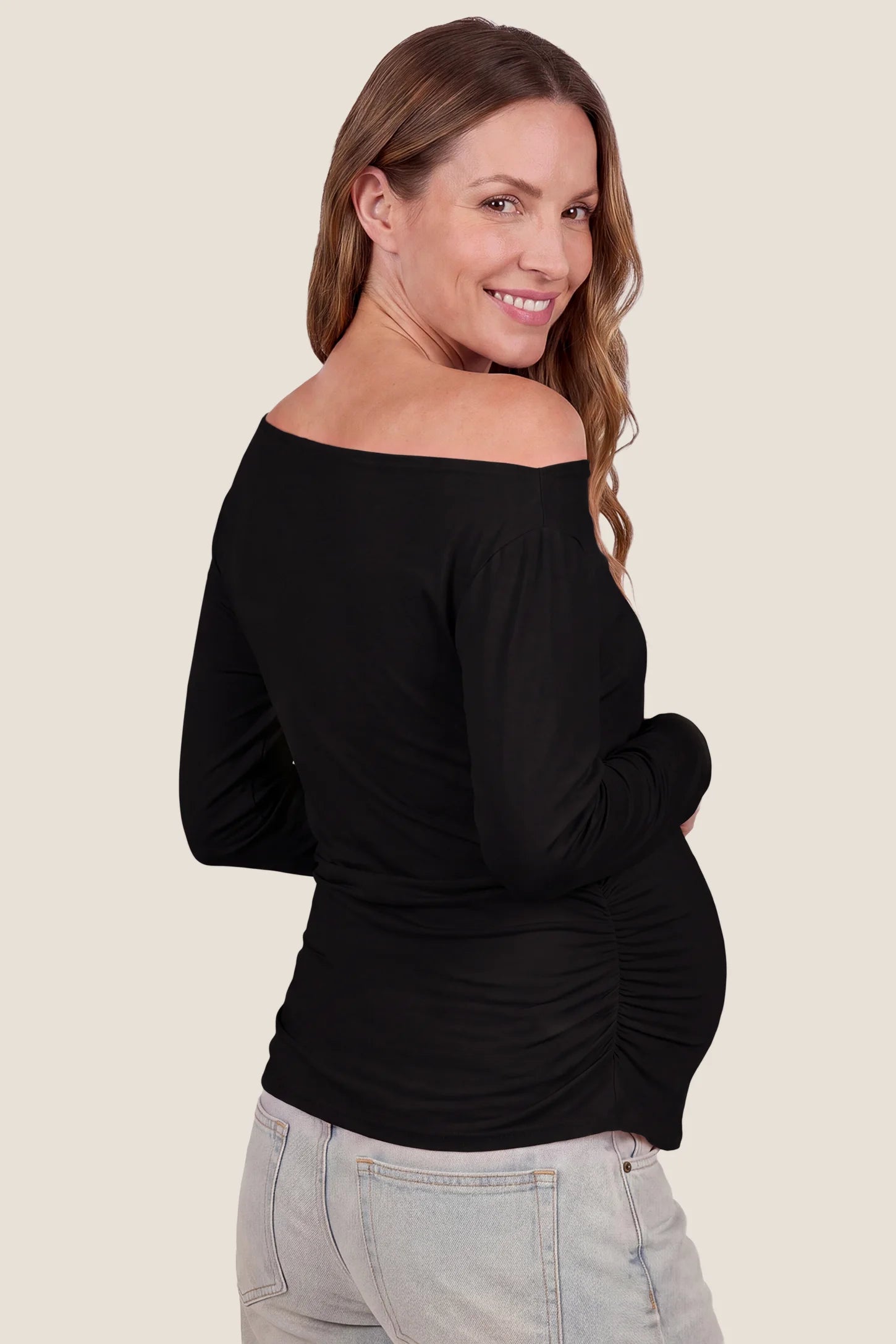 Elegant Black Ruched Side Off-Shoulder Maternity Top Elegant Ruched Side Off-Shoulder Maternity Top in Black featuring a smooth lightweight fabric, off-shoulder neckline, stretchy fit, and a sleek body-hugging silhouette on a pregnant model, back view.