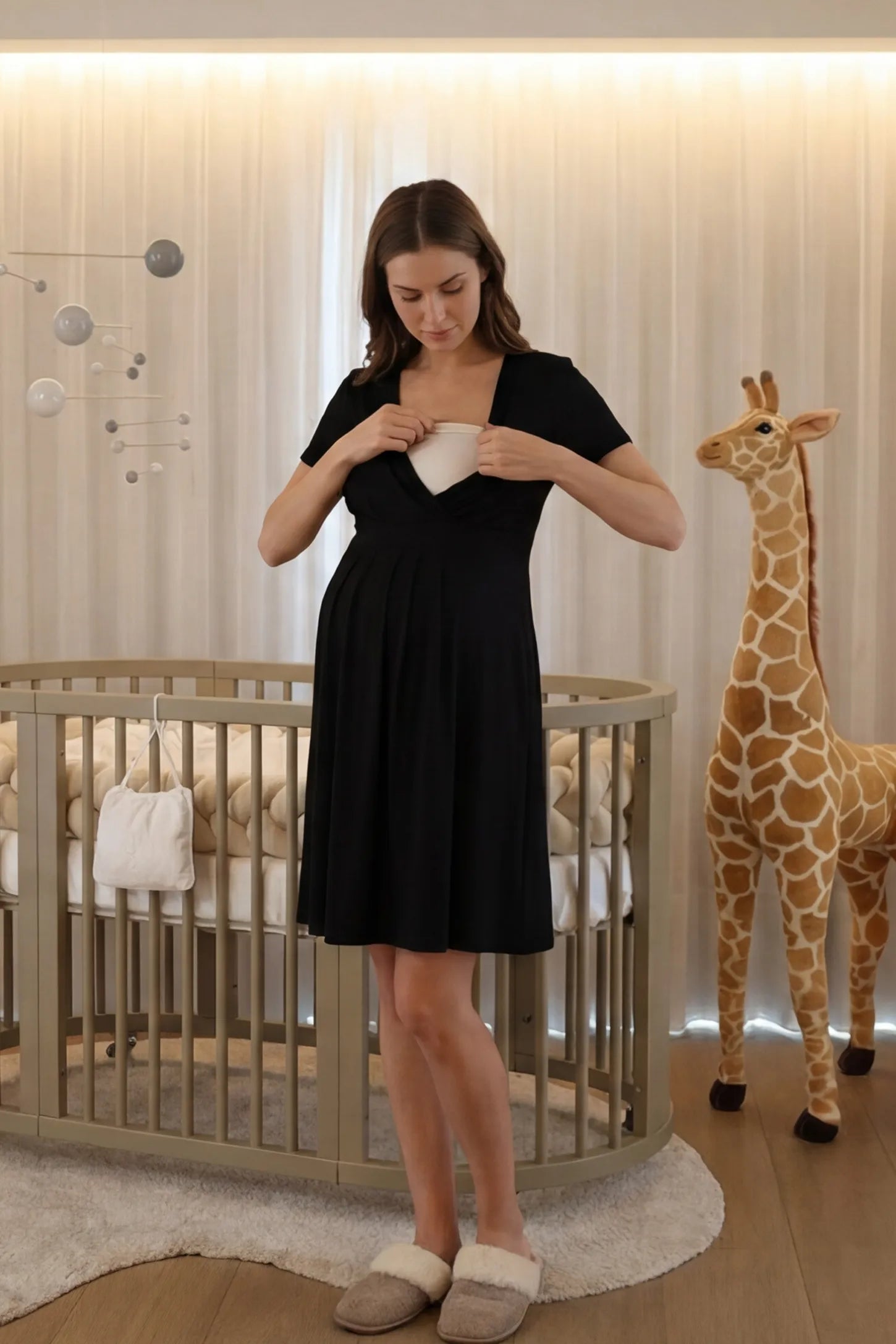 V-Neck Empire Waist Short Maternity & Nursing Dress V-Neck Empire Waist Short Maternity and Nursing Dress in black featuring easy nursing access in full body front view on a UGC model