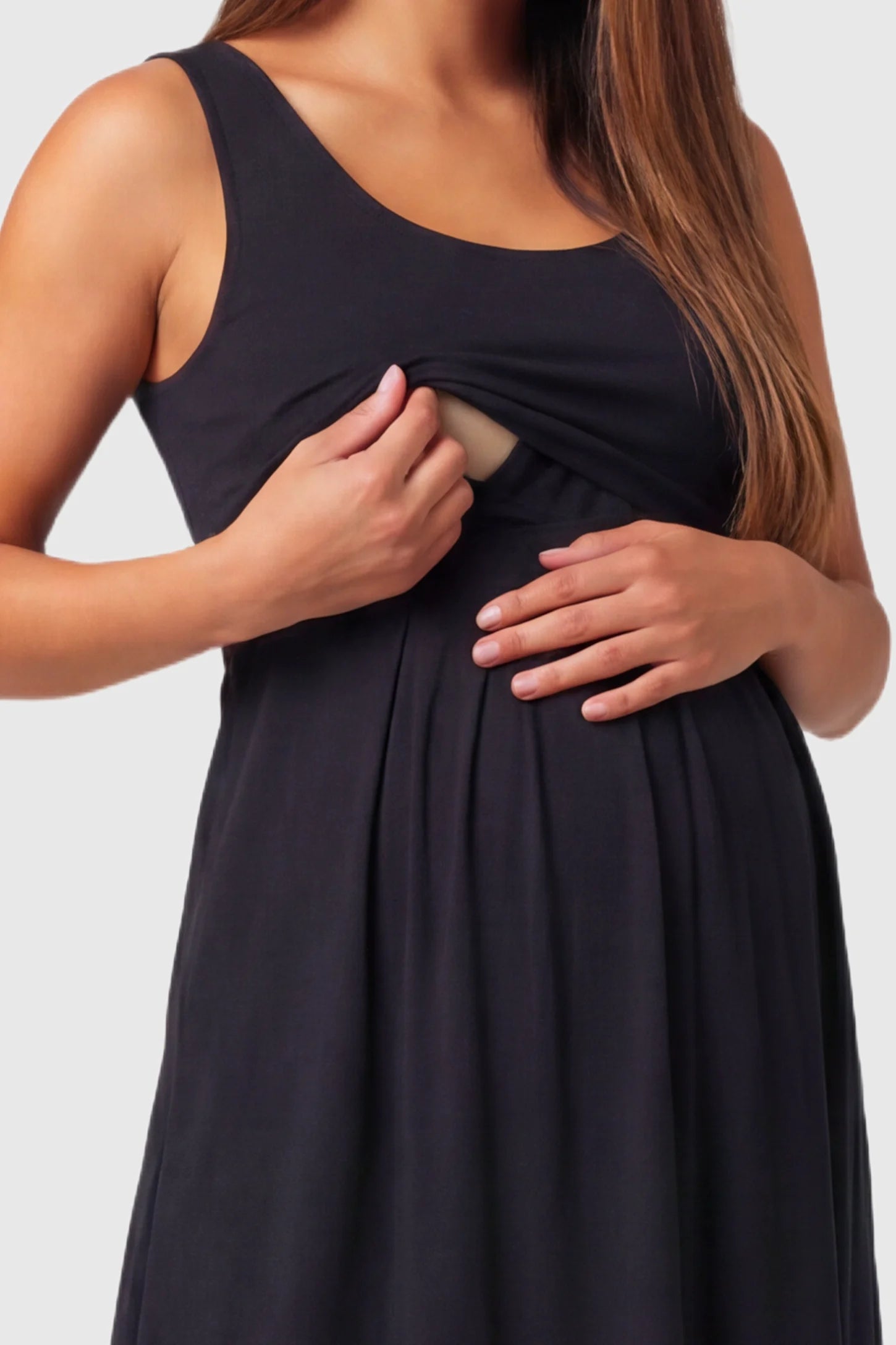 Sleeveless Empire Waist Maternity & Nursing Maxi Dress Sleeveless Empire Waist Maternity & Nursing Maxi Dress in black featuring , discreet nursing access and flowing A-line silhouette on a pregnant  model.