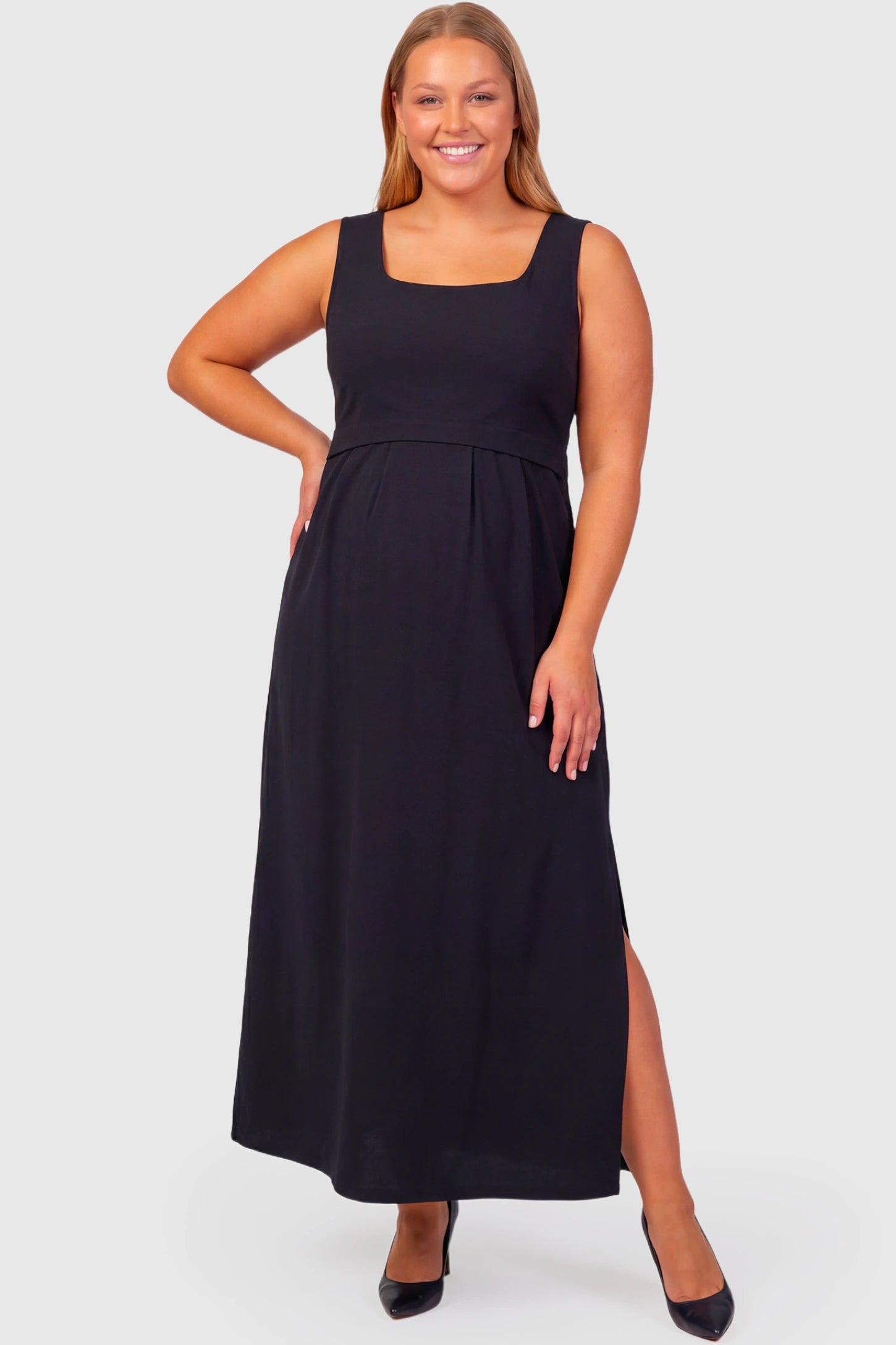 Sleeveless Empire Waist Maternity & Nursing Maxi Dress Sleeveless Empire Waist Maternity & Nursing Maxi Dress in black featuring scoop neck, fitted bodice, and flowing A-line silhouette on a plus size pregnant  model.