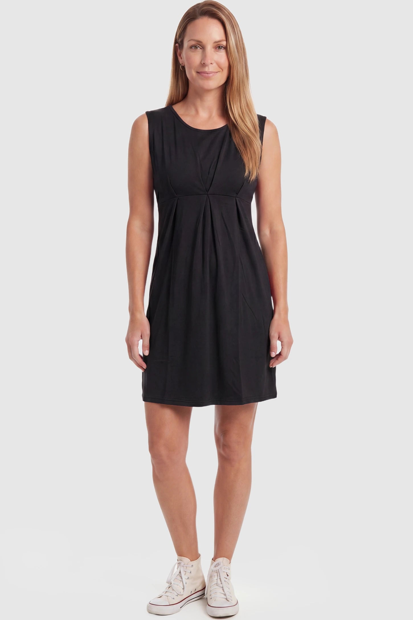 Sleeveless Empire Waist Maternity Short Dress Sleeveless empire waist maternity short dress in black with short length and sleeveless design, front view on postpartum model