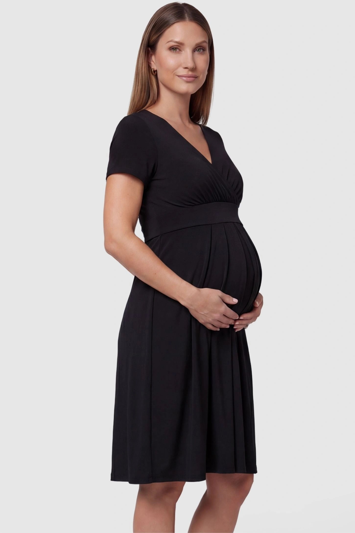 V-Neck Empire Waist Short Maternity & Nursing Dress V-Neck Empire Waist Short Maternity and Nursing Dress in black featuring short-sleeve in full body side view on a pregnant model