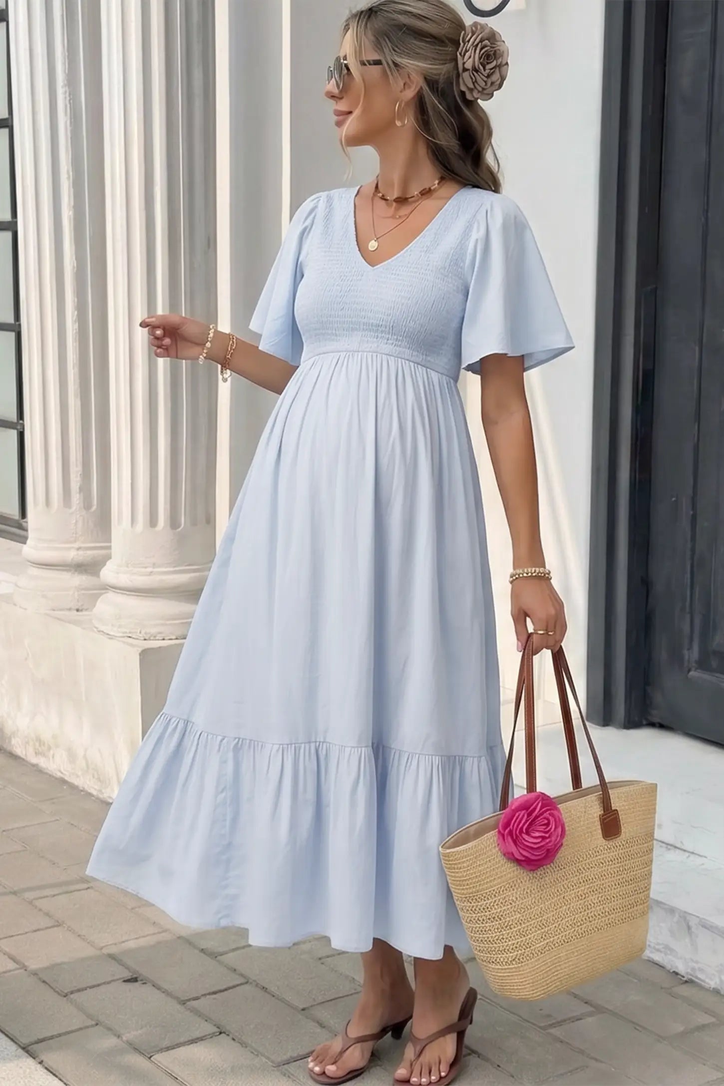 Smocked Empire Waist Tiered Skirt Maternity Midi Dress Smocked empire waist tiered skirt maternity midi dress in light blue with V-neckline and stretchy smocked bodice, editorial lifestyle view
