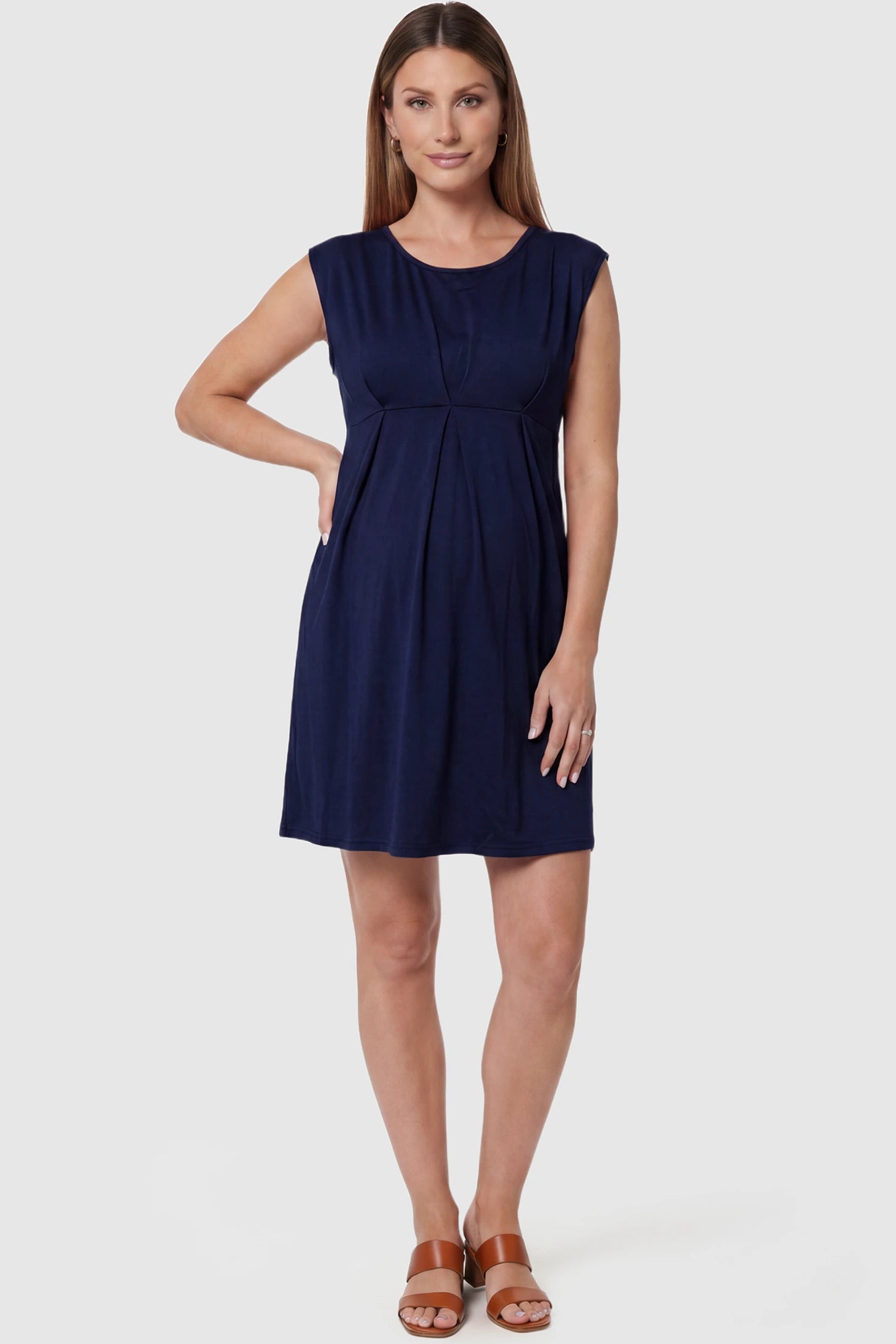 Sleeveless Empire Waist Maternity Short Dress Sleeveless empire waist maternity short dress in navy blue with short length and sleeveless design, front view on pregnant model