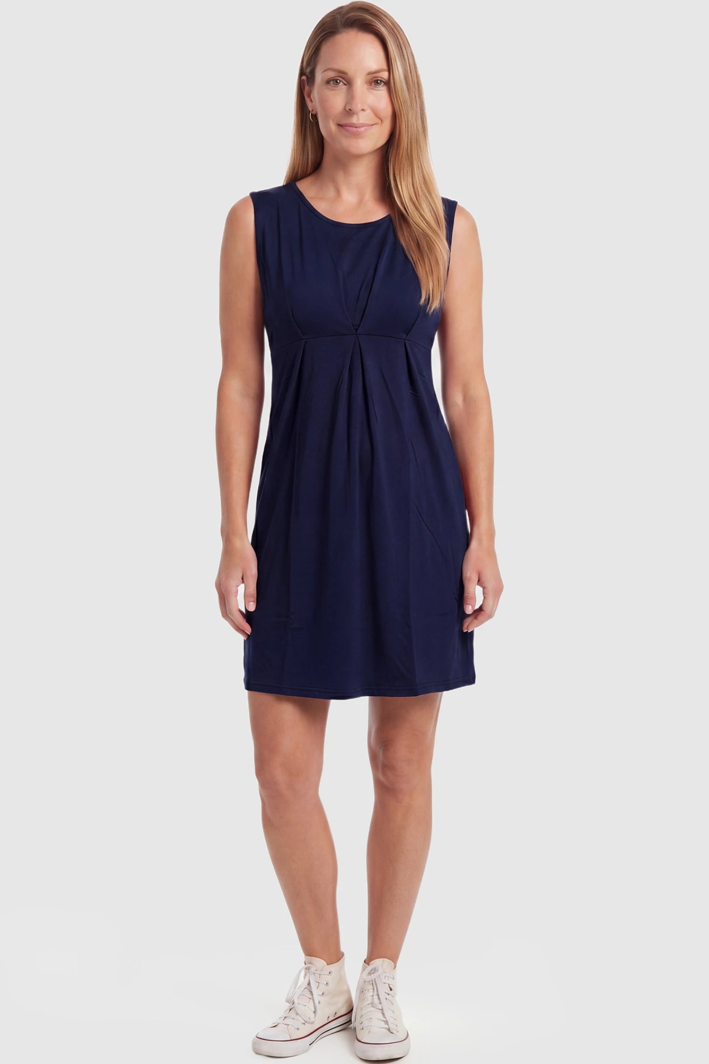 Sleeveless Empire Waist Maternity Short Dress Sleeveless empire waist maternity short dress in navy blue with short length and sleeveless design, front view on postpartum model