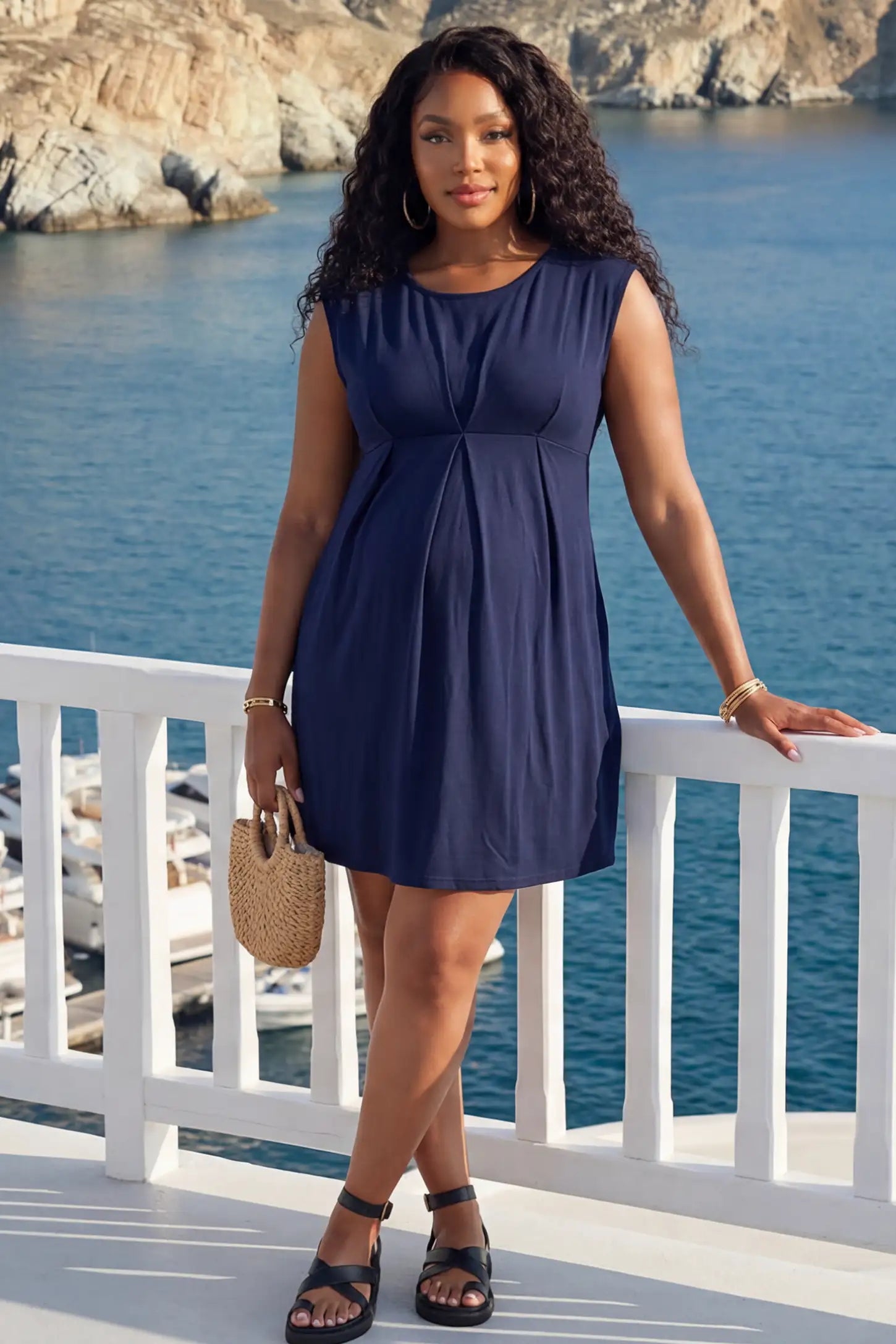 Sleeveless Empire Waist Maternity Short Dress Sleeveless empire waist maternity short dress in navy blue with short length and sleeveless design, front view on pregnant model