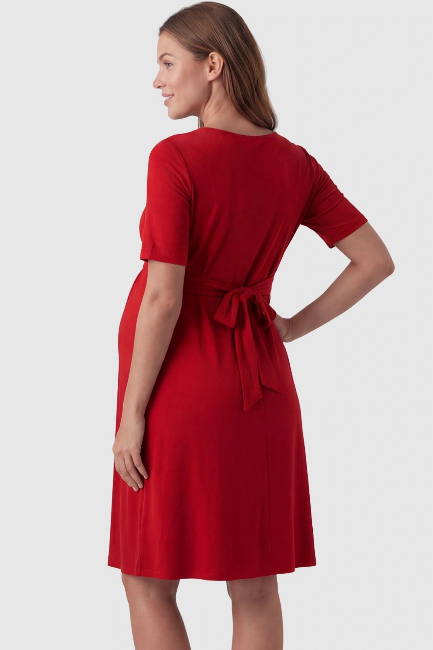 V-Neck Empire Waist Short Maternity & Nursing Dress V-Neck Empire Waist Short Maternity and Nursing Dress in red featuring adjustable tie in full body back view on a pregnant model