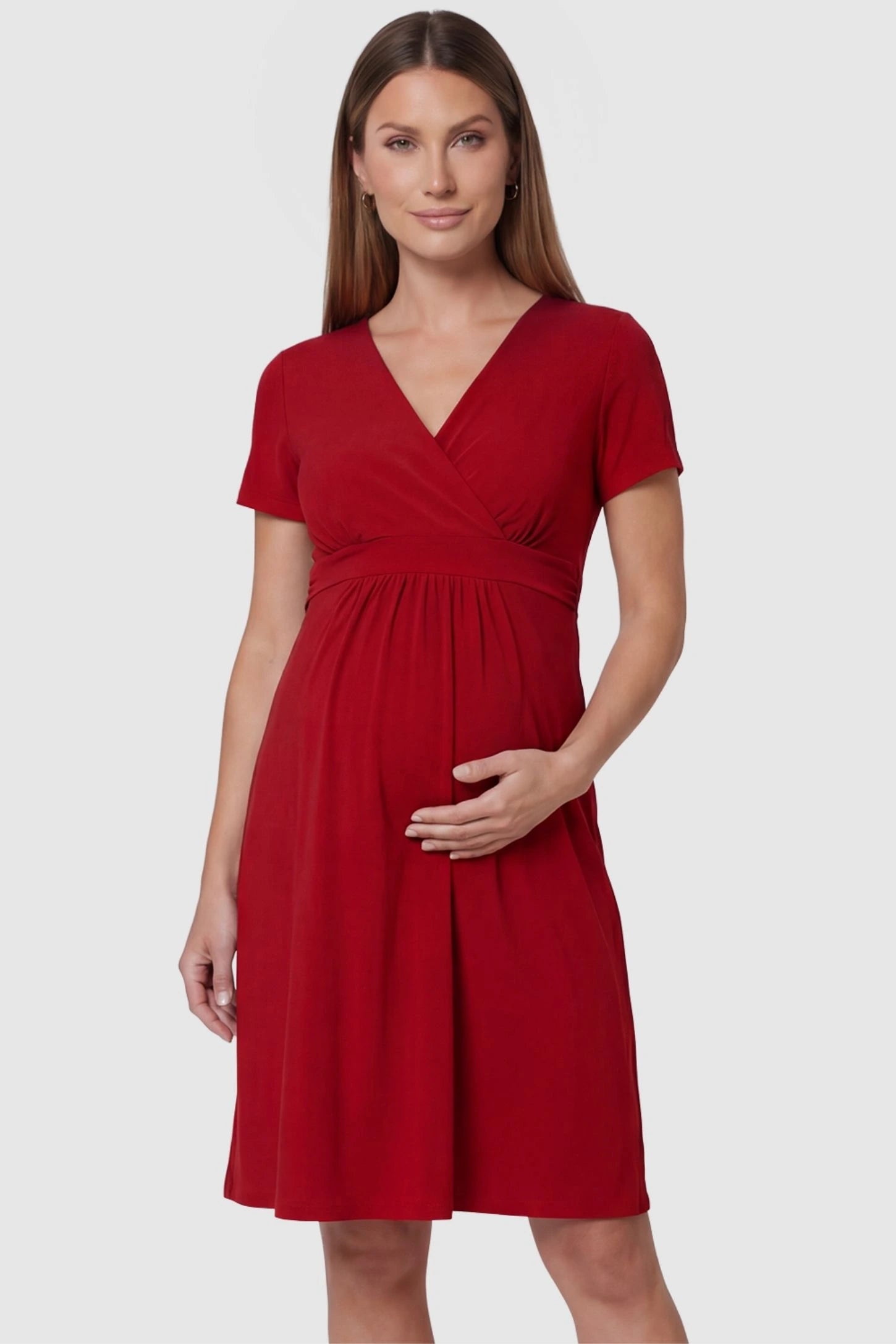 V-Neck Empire Waist Short Maternity & Nursing Dress V-Neck Empire Waist Short Maternity and Nursing Dress in red featuring A-line silhouette in full body front view on a pregnant model