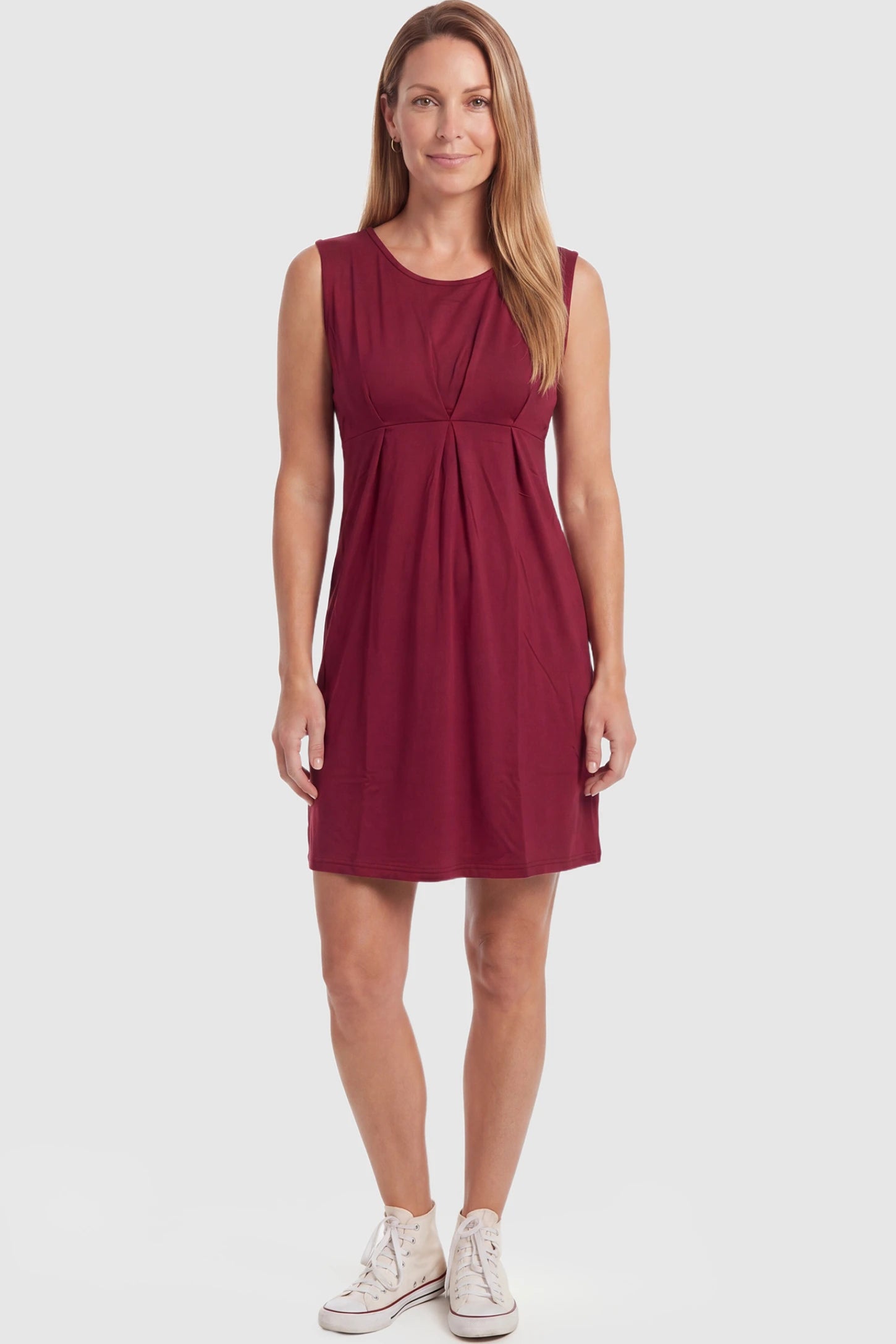 Sleeveless Empire Waist Maternity Short Dress Sleeveless empire waist maternity short dress in wine red with short length and sleeveless design, front view on postpartum model