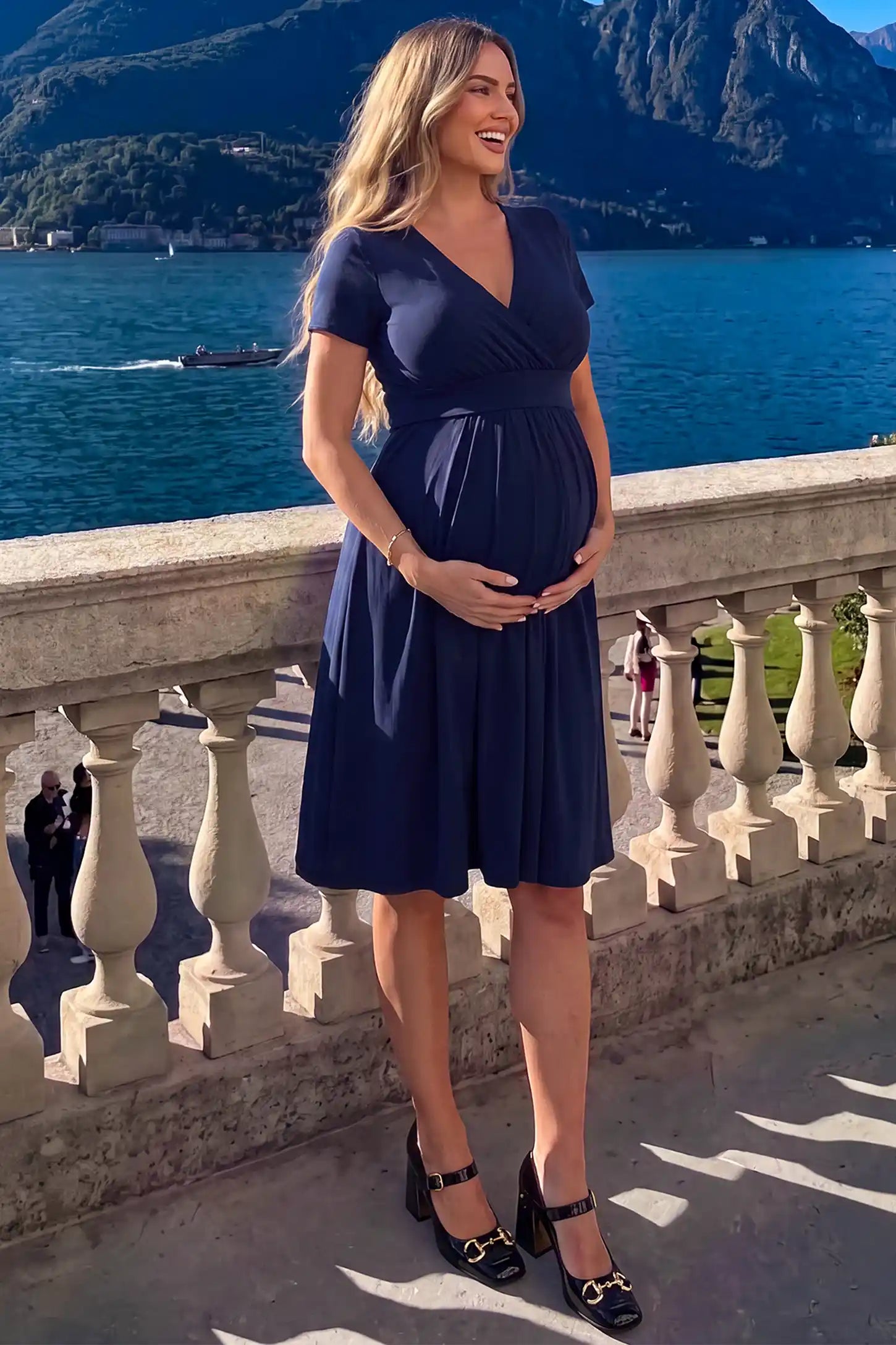 V-Neck Empire Waist Short Maternity and Nursing Dress in navy blue featuring easy nursing access in full body front view on a UGC model