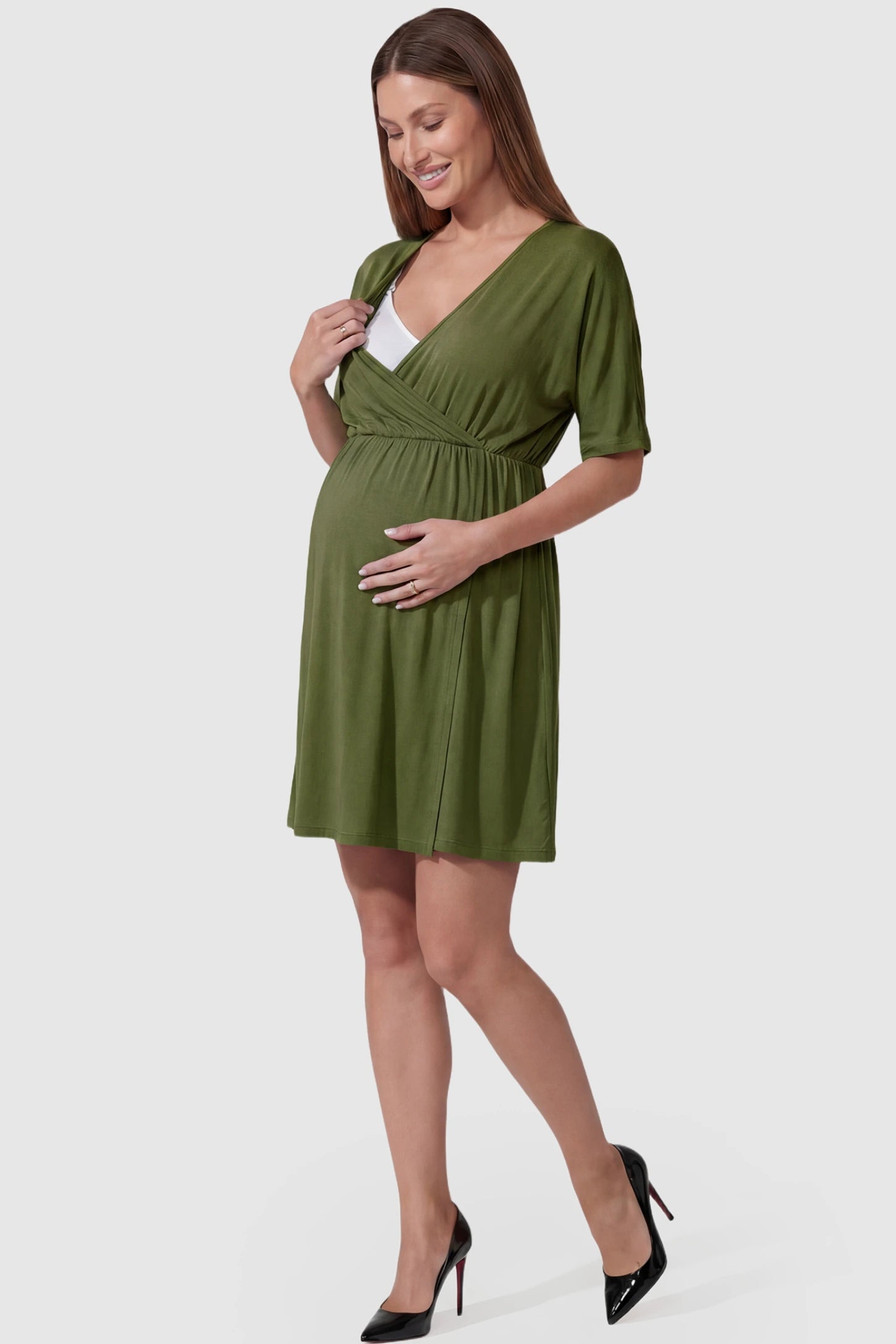Wrap Front Empire Waist Maternity & Nursing Mini Dress Wrap Front Empire Waist Maternity & Nursing Dress in army green featuring a draped crossover V-neck and short sleeves on pregnant model.