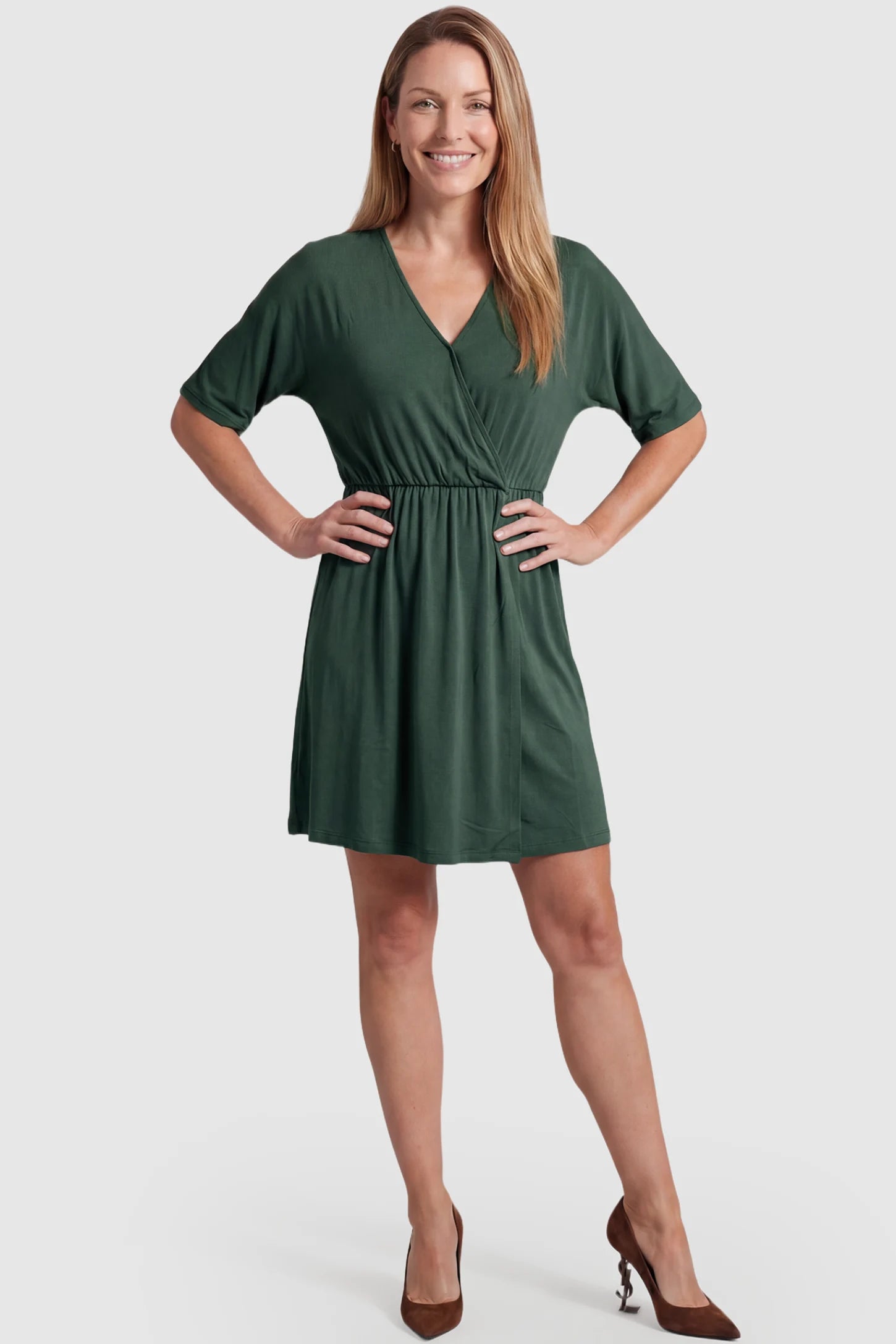 Wrap Front Empire Waist Maternity & Nursing Mini Dress Wrap Front Empire Waist Maternity & Nursing Dress in dark green featuring a draped crossover V-neck and short sleeves on non pregnant model.