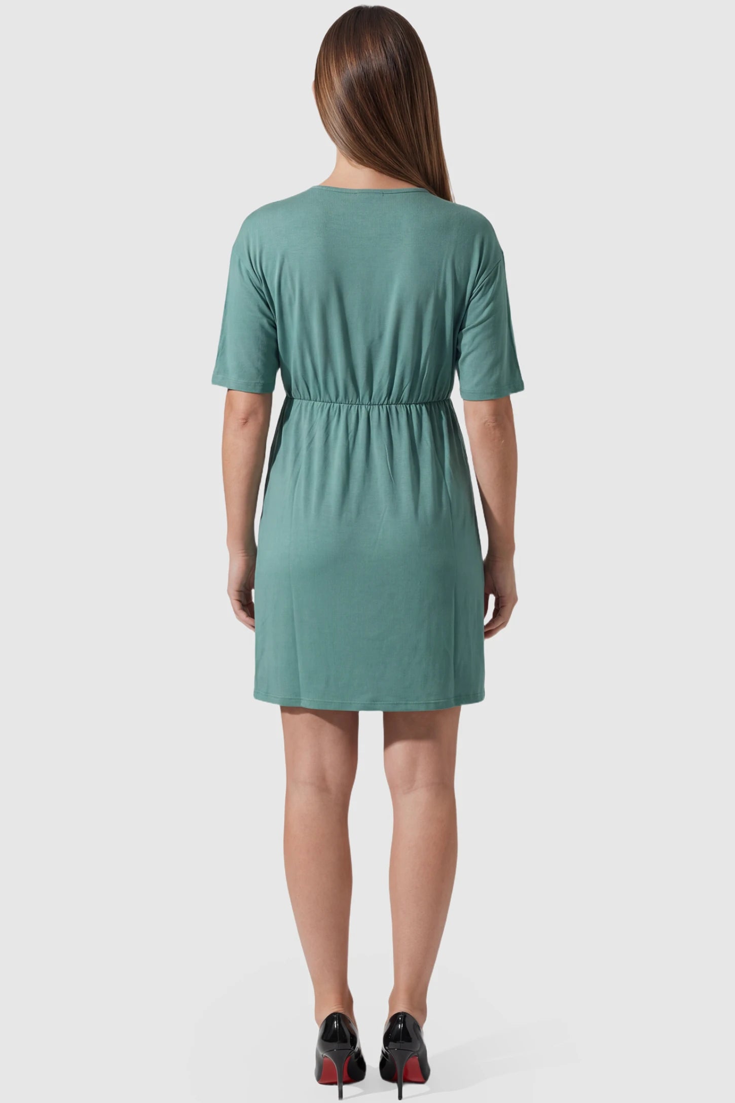 Wrap Front Empire Waist Maternity & Nursing Mini Dress Wrap Front Empire Waist Maternity & Nursing Dress in green featuring short sleeves on pregnant model back view.