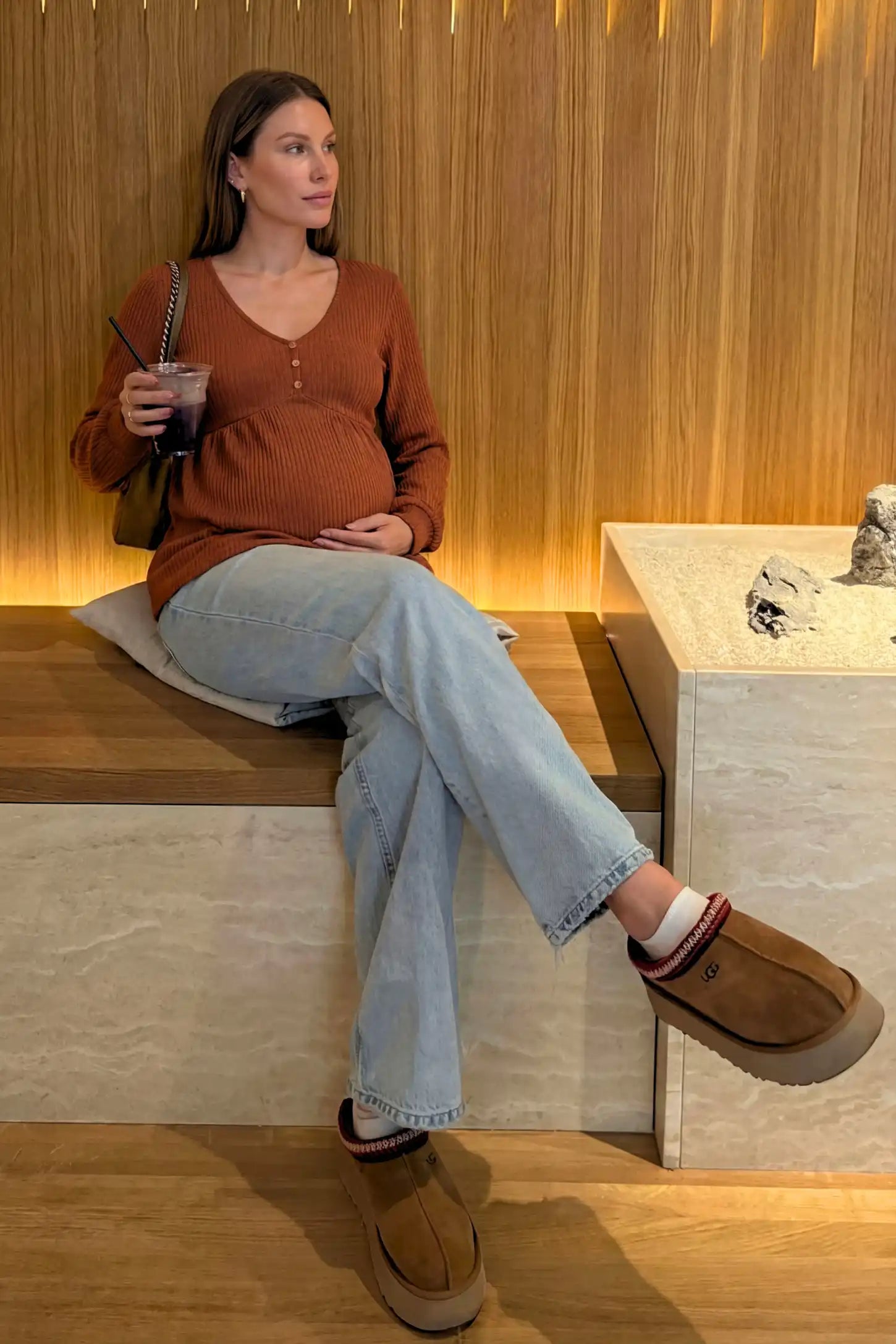 Ribbed Knit Empire Waist Maternity Top Ribbed Knit Empire Waist Maternity Top in brown featuring a v-neckline and ribbed knit texture on a pregnant model.