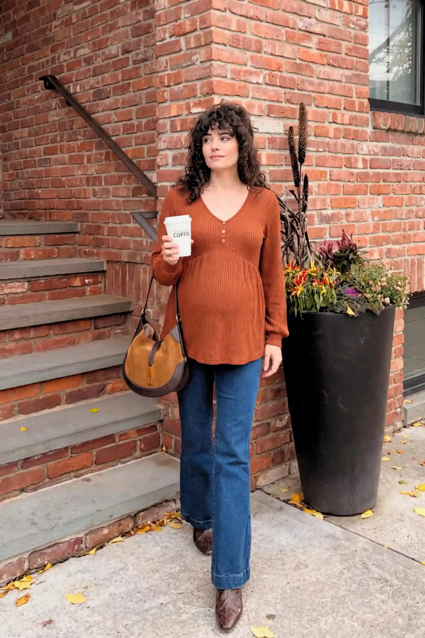Ribbed Knit Empire Waist Maternity Top Ribbed Knit Empire Waist Maternity Top in brown featuring a v-neckline and ribbed knit texture on a pregnant model.