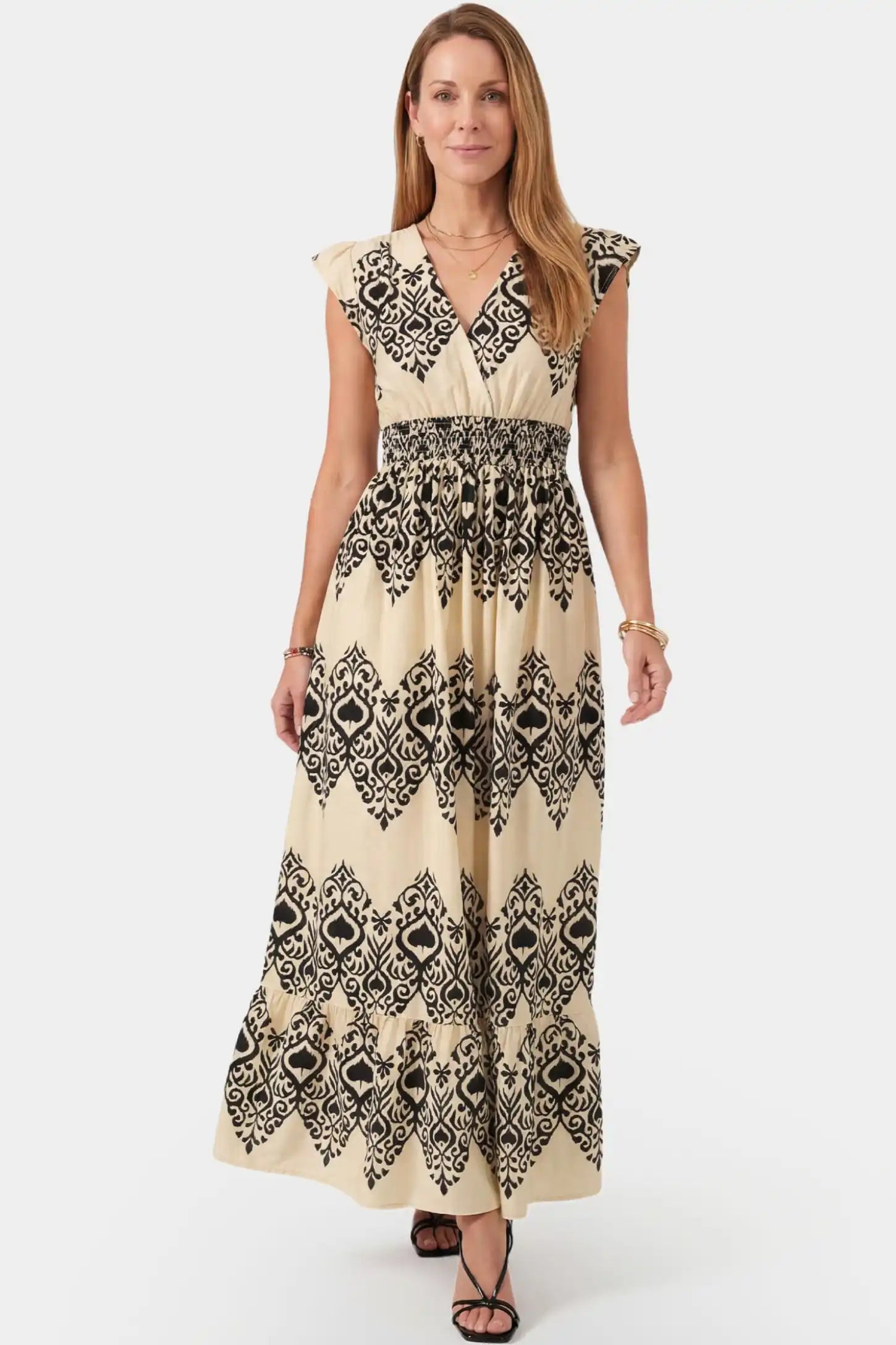Ethnic Print V-Neck Cap Sleeve A-line Maxi Maternity Dress Ethnic print V-neck cap sleeve A-line maxi maternity dress in beige featuring ethnic print and V-neckline in front view on a postpartum model