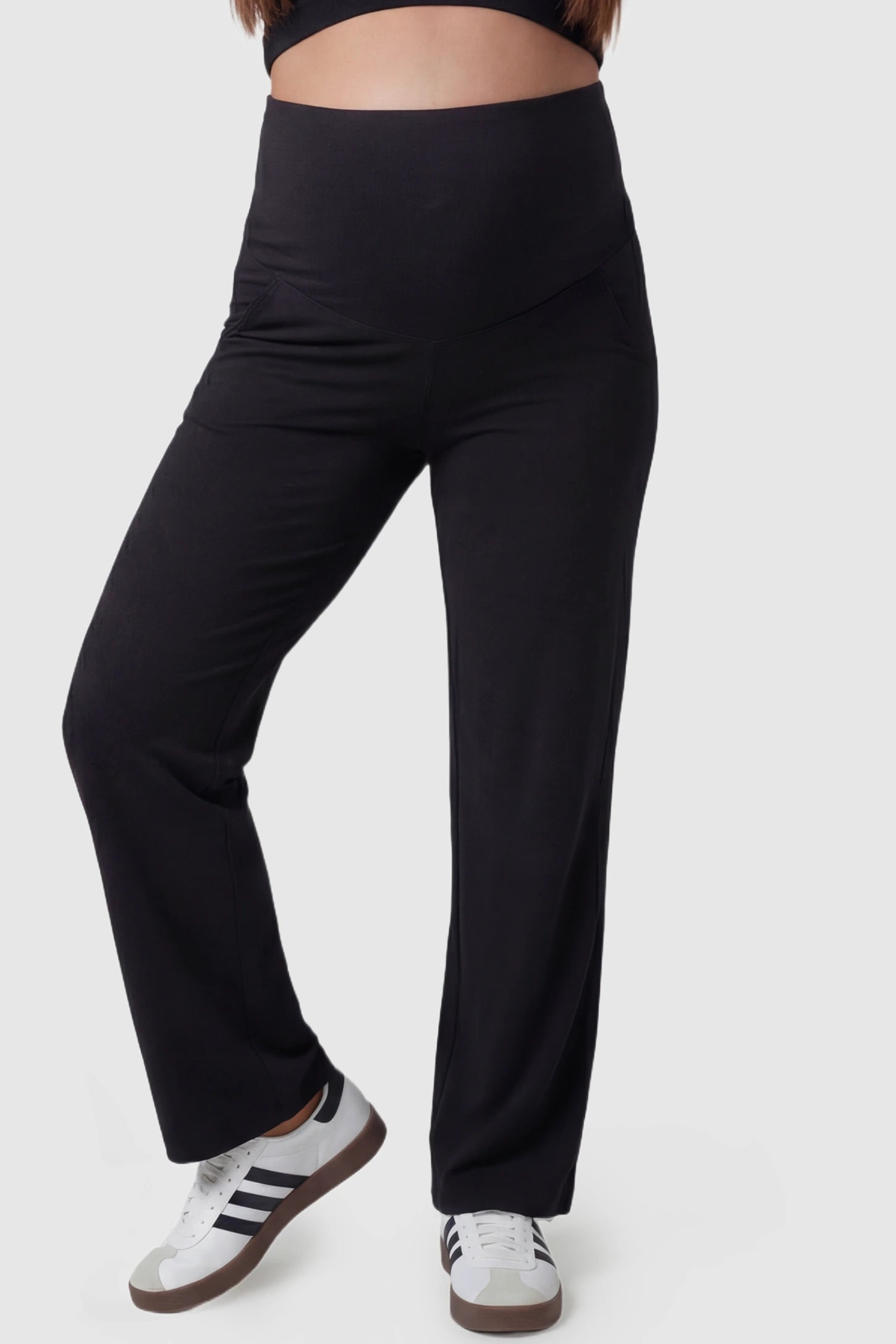 High Waist Full Panel Flare Leg Maternity Pants in black featuring over-the-belly high stretch fit on pregnant model.