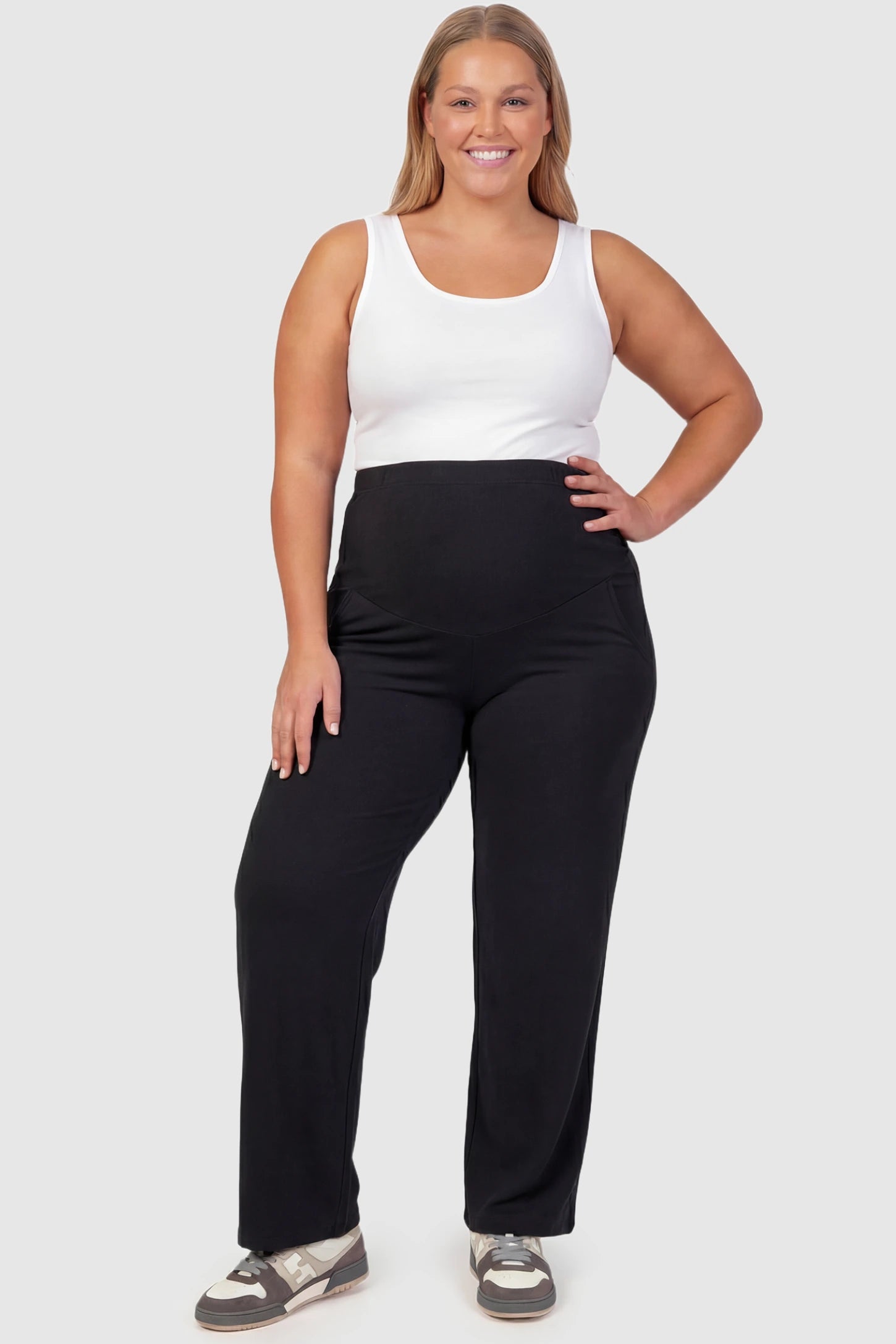 High Waist Full Panel Flare Leg Maternity Pants High Waist Full Panel Flare Leg Maternity Pants in black featuring over-the-belly high stretch fit on plus size pregnant model.