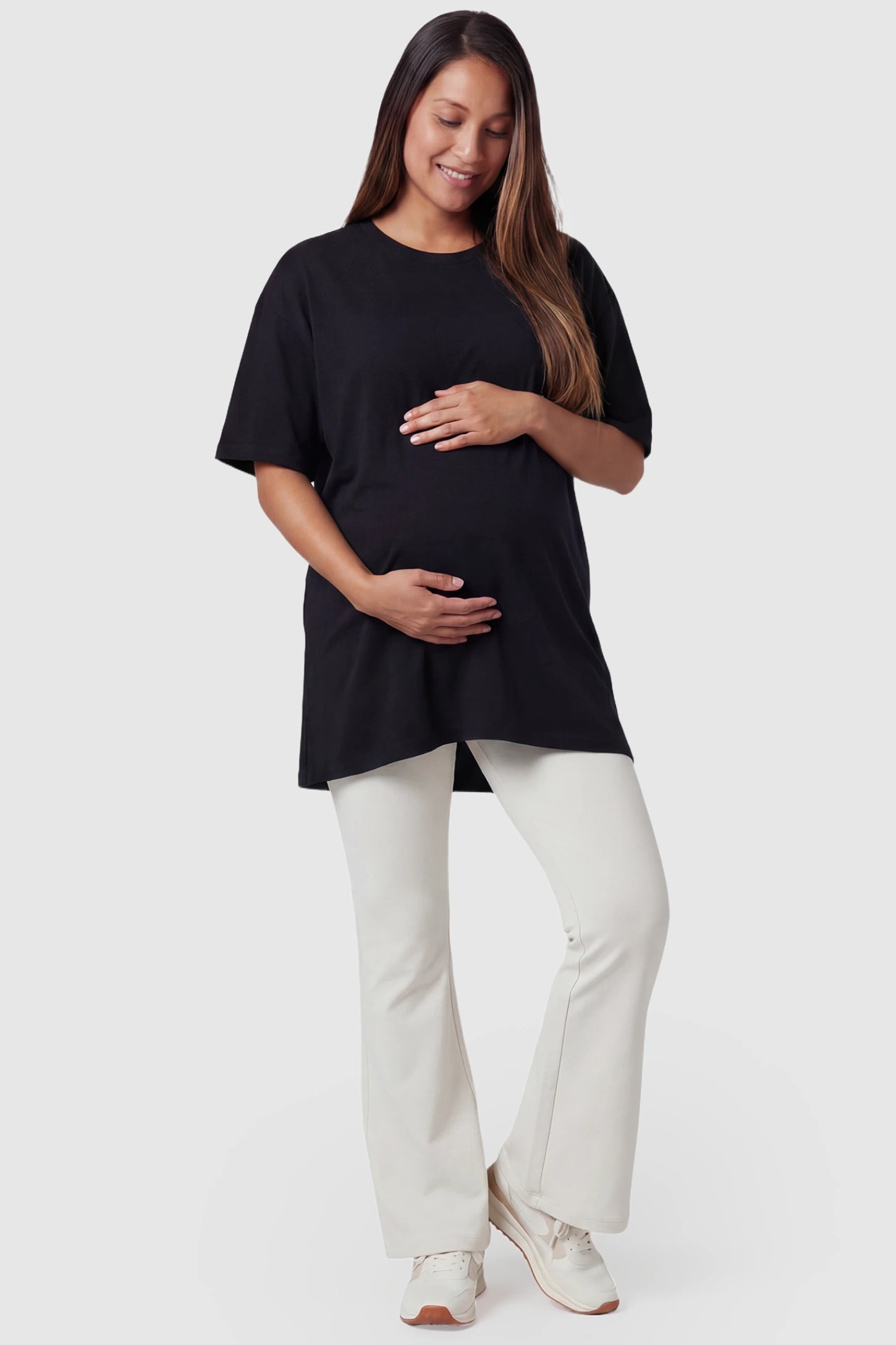 Full-Panel Flared Maternity Pants Full-Panel Flared Maternity Pants in beige featuring high-waisted bump panel and full-length bootcut silhouette on pregnant model.