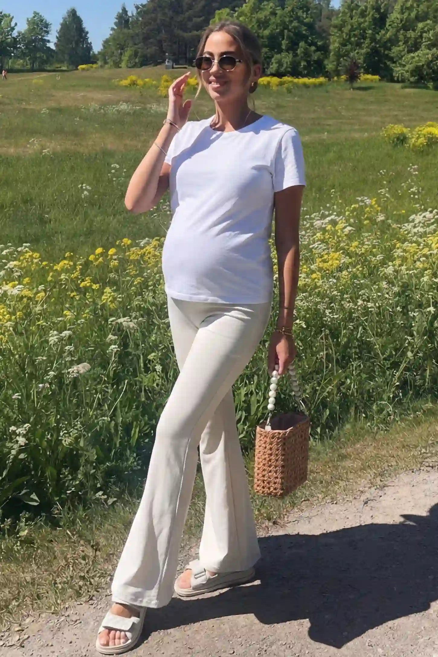 Full-Panel Flared Maternity Pants Full-Panel Flared Maternity Pants in beige featuring high-waisted bump panel and full-length bootcut silhouette on pregnant model.