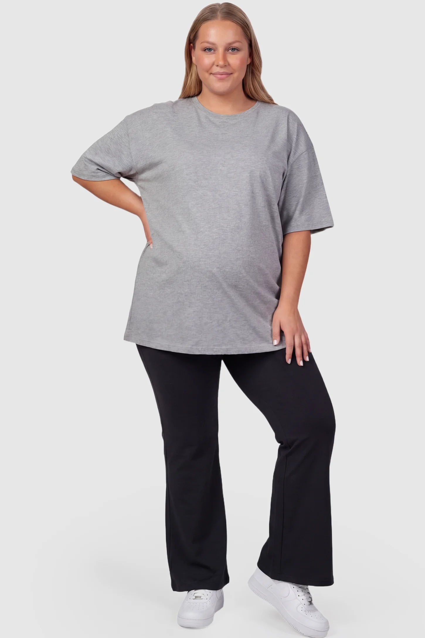 Full-Panel Flared Maternity Pants Full-Panel Flared Maternity Pants in black featuring high-waisted bump panel and full-length bootcut silhouette on plus size pregnant model.