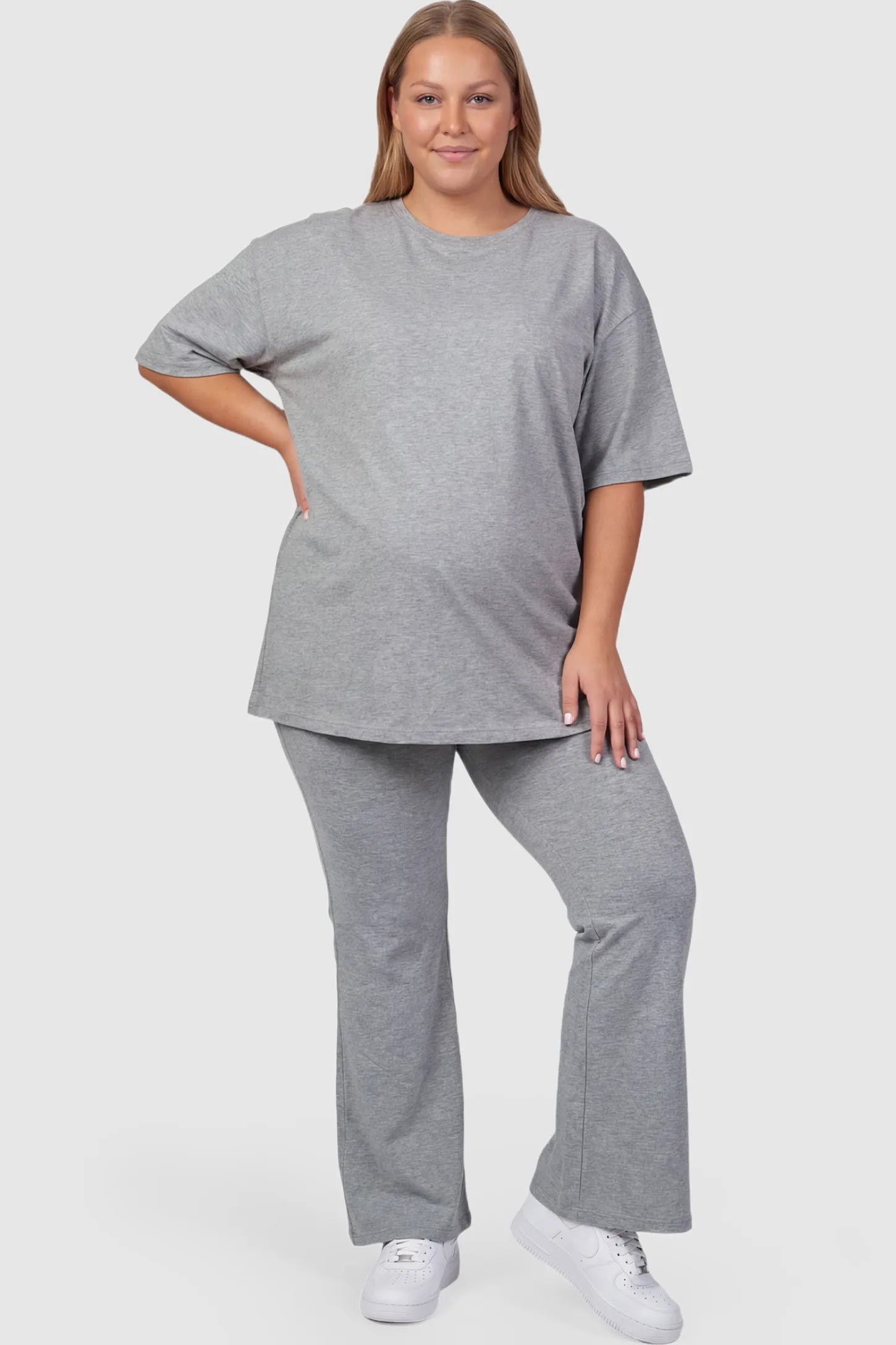 Full-Panel Flared Maternity Pants Full-Panel Flared Maternity Pants in gray featuring high-waisted bump panel and full-length bootcut silhouette on plus size pregnant model.