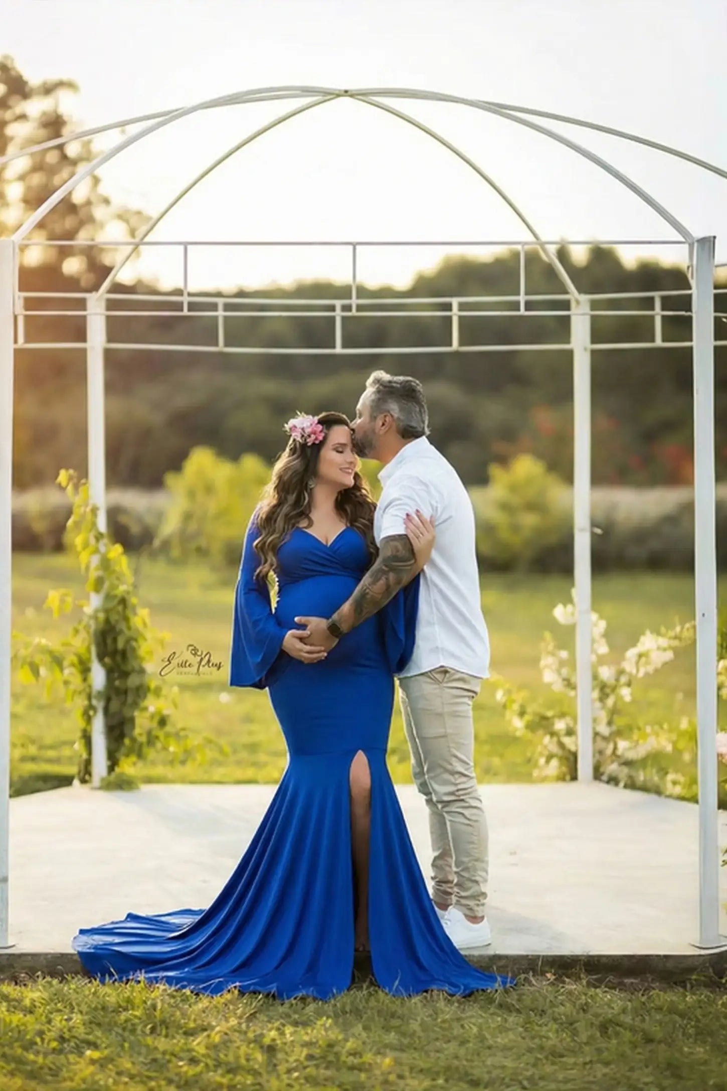 Blue Wrap Flared Fishtail Maternity Gown featuring long bell sleeves on a pregnant model in a front view.