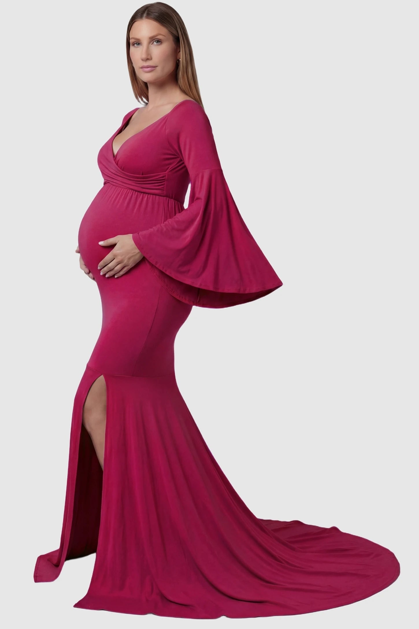 Wrap Flared Fishtail Maternity Gown Wrap Flared Fishtail Maternity Gown in Magenta featuring a dramatic long train on a pregnant model side view.