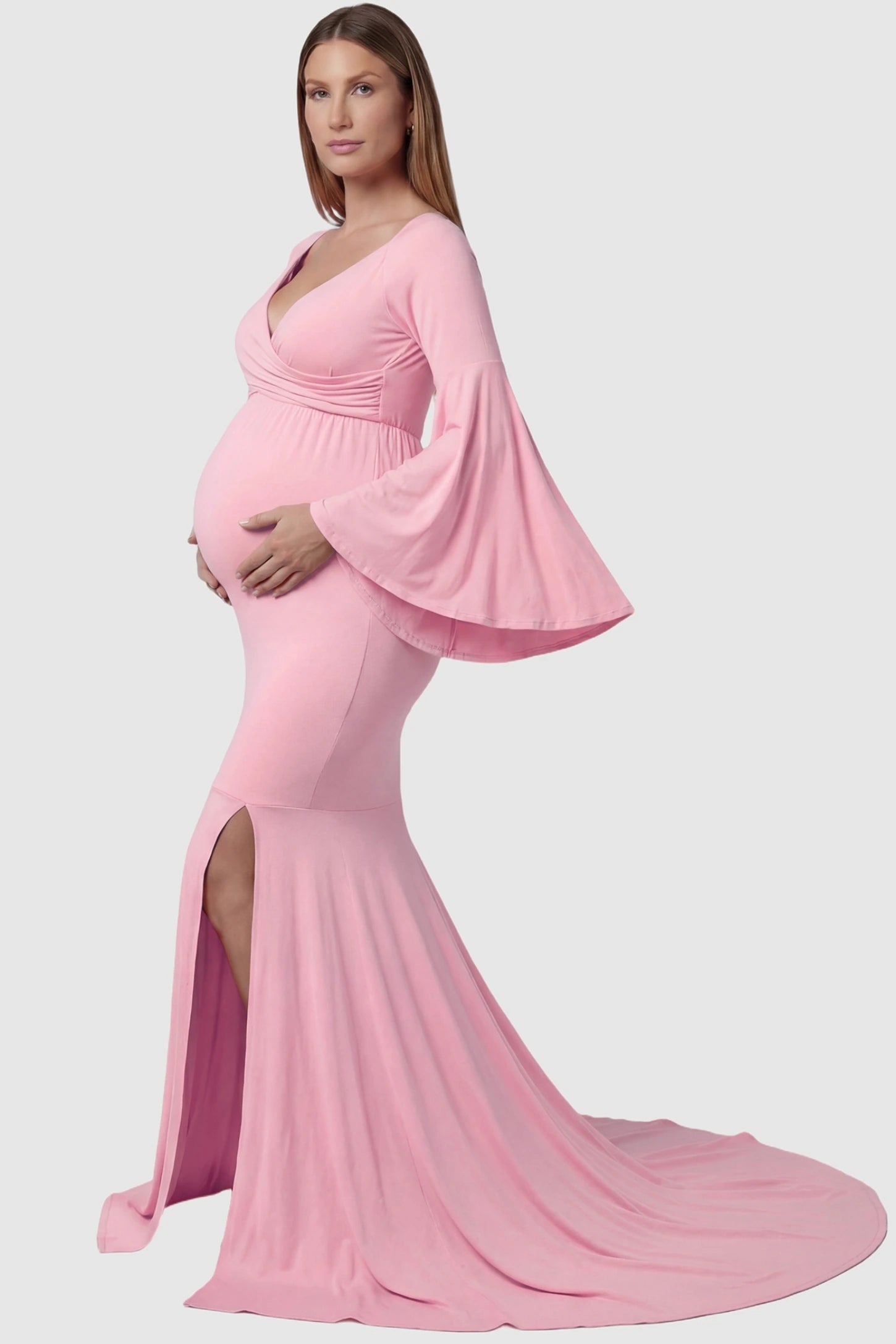 Wrap Flared Fishtail Maternity Gown Wrap Flared Fishtail Maternity Gown in Pink featuring a dramatic long train on a pregnant model side view.
