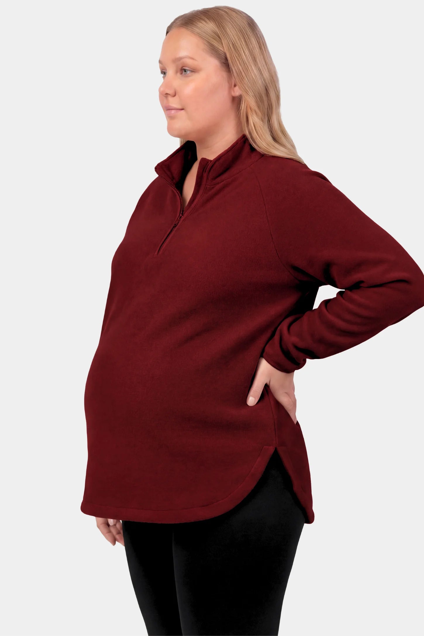 Fleece Mock Neck with Half-Zip Maternity Sweater Fleece Mock Neck with Half-Zip Maternity Sweater in burgundy featuring a mock neck and half-zip detail on a pregnant model.