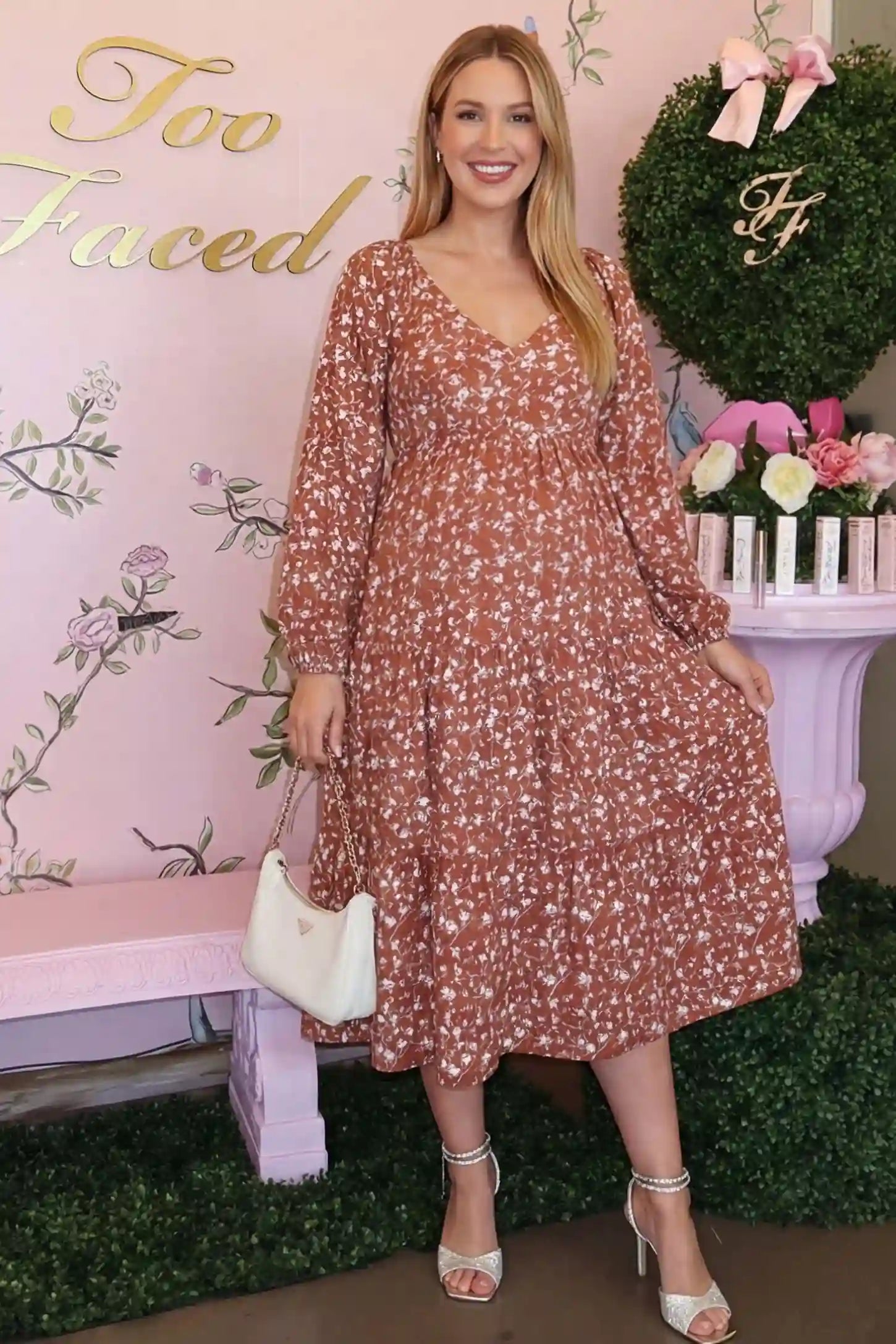 Floral Balloon Sleeves Midi Maternity Dress Floral Balloon Sleeves Midi Maternity Dress in Brown featuring a V-neckline on a front-facing pregnant model.