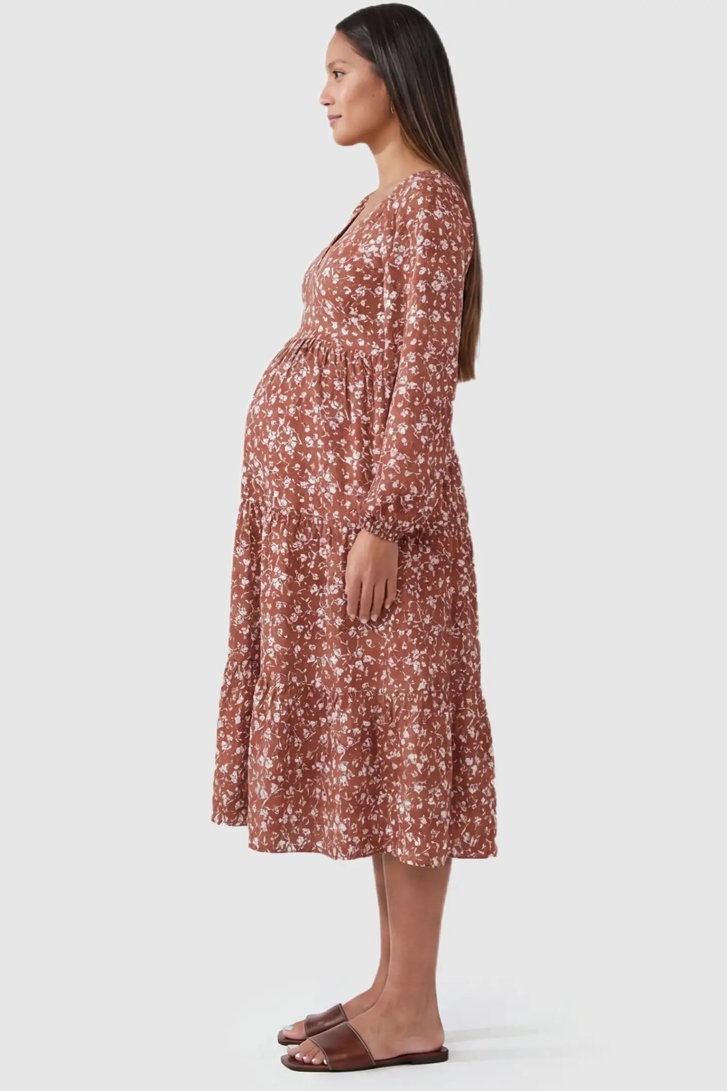 Floral Balloon Sleeves Midi Maternity Dress Brown Floral Balloon Sleeves Midi Maternity Dress featuring a tiered skirt on a side-profile pregnant model.