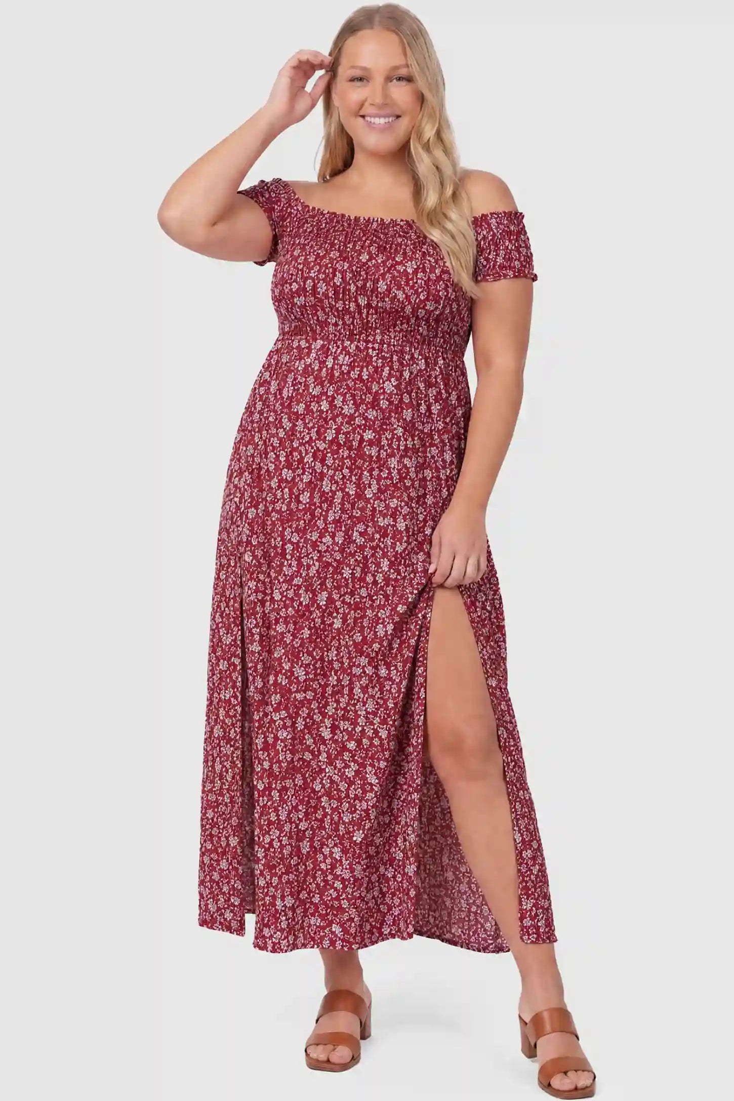 Floral Off-Shoulder Smocked Bodice Maxi Maternity Dress Floral off-shoulder smocked bodice maxi maternity dress in burgundy featuring smocked neckline in front view on a plus-size model
