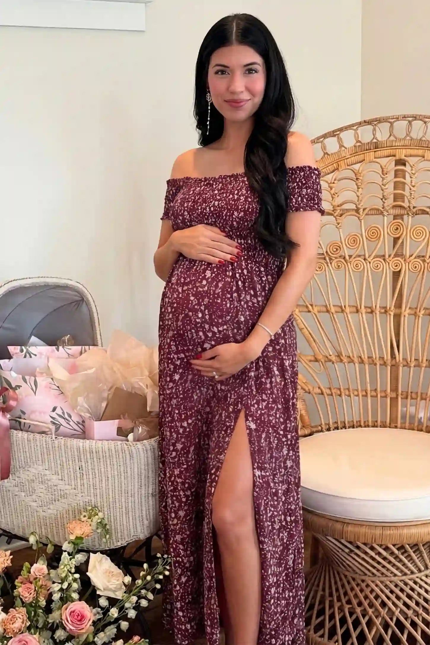 Floral Off-Shoulder Smocked Bodice Maxi Maternity Dress Floral off-shoulder smocked bodice maxi maternity dress in burgundy featuring smocked neckline in front view on a UGC model