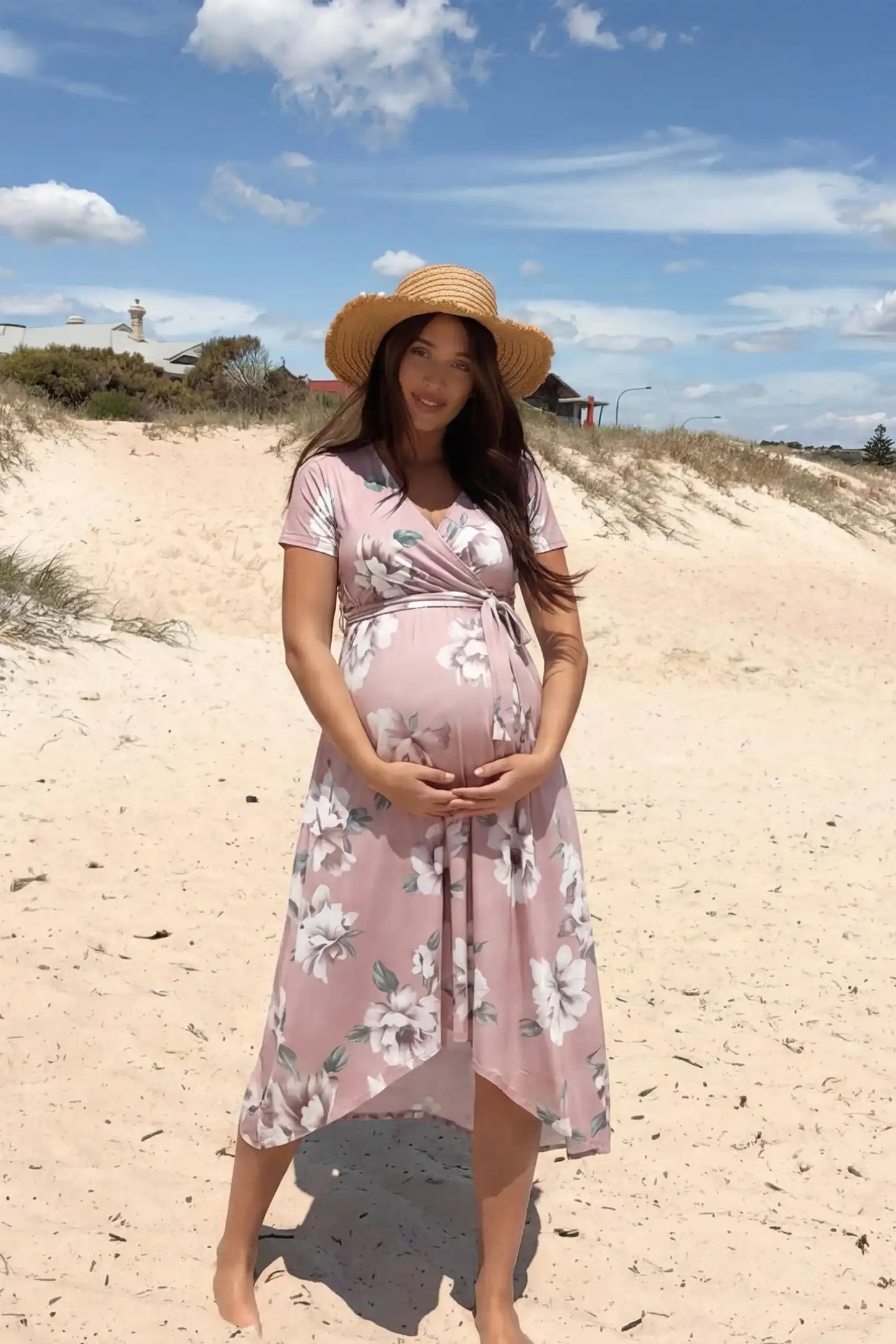 Floral V-neck wrap high-low maxi maternity dress in light pink floral with relaxed fit, lifestyle UGC model