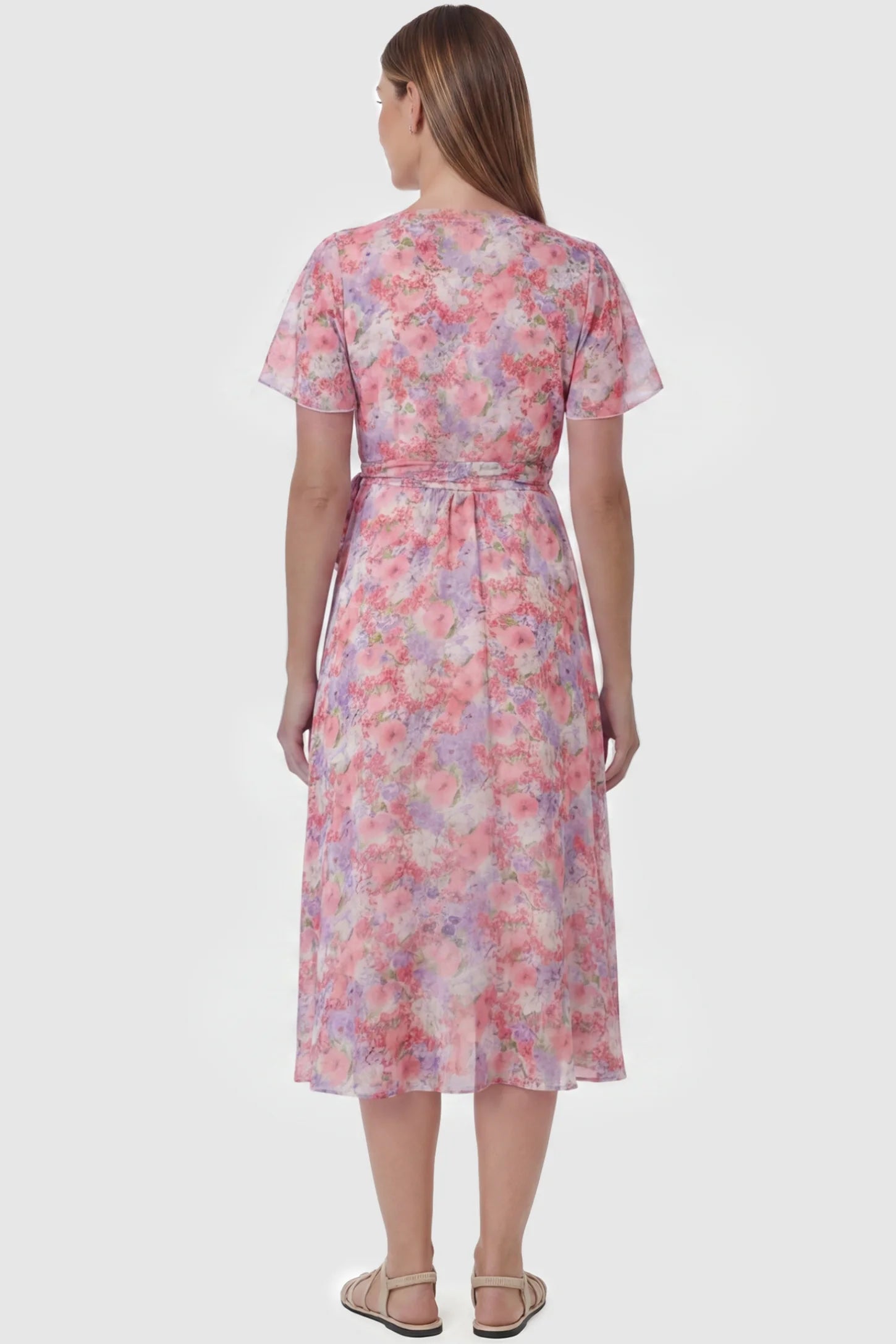 Floral V-Neck Ruffled Hem Midi Maternity Dress Floral V-neck ruffled hem midi maternity dress in pink featuring V-neckline and tie waist in full body front view on a pregnant model, back view.