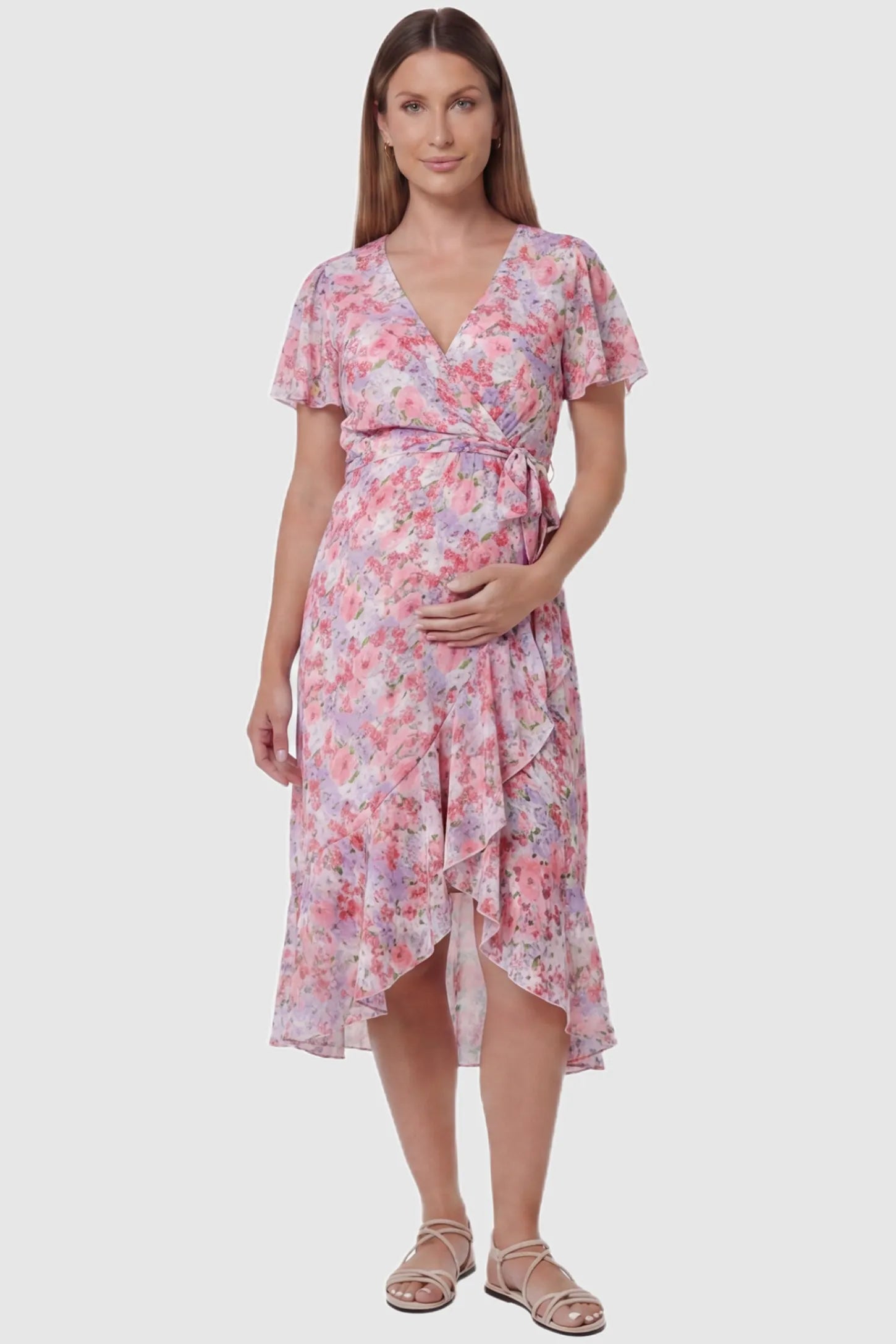 Floral V-Neck Ruffled Hem Midi Maternity Dress Floral V-neck ruffled hem midi maternity dress in pink featuring V-neckline and tie waist in full body front view on a pregnant model, front view.