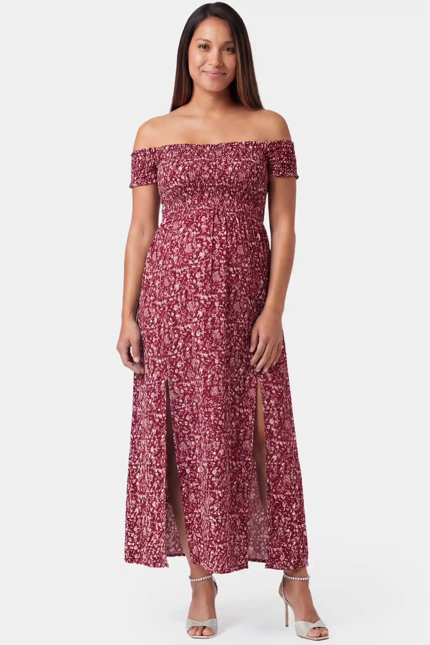 Floral Off-Shoulder Smocked Bodice Maxi Maternity Dress Floral off-shoulder smocked bodice maxi maternity dress in red featuring smocked neckline in front view on a pregnant model