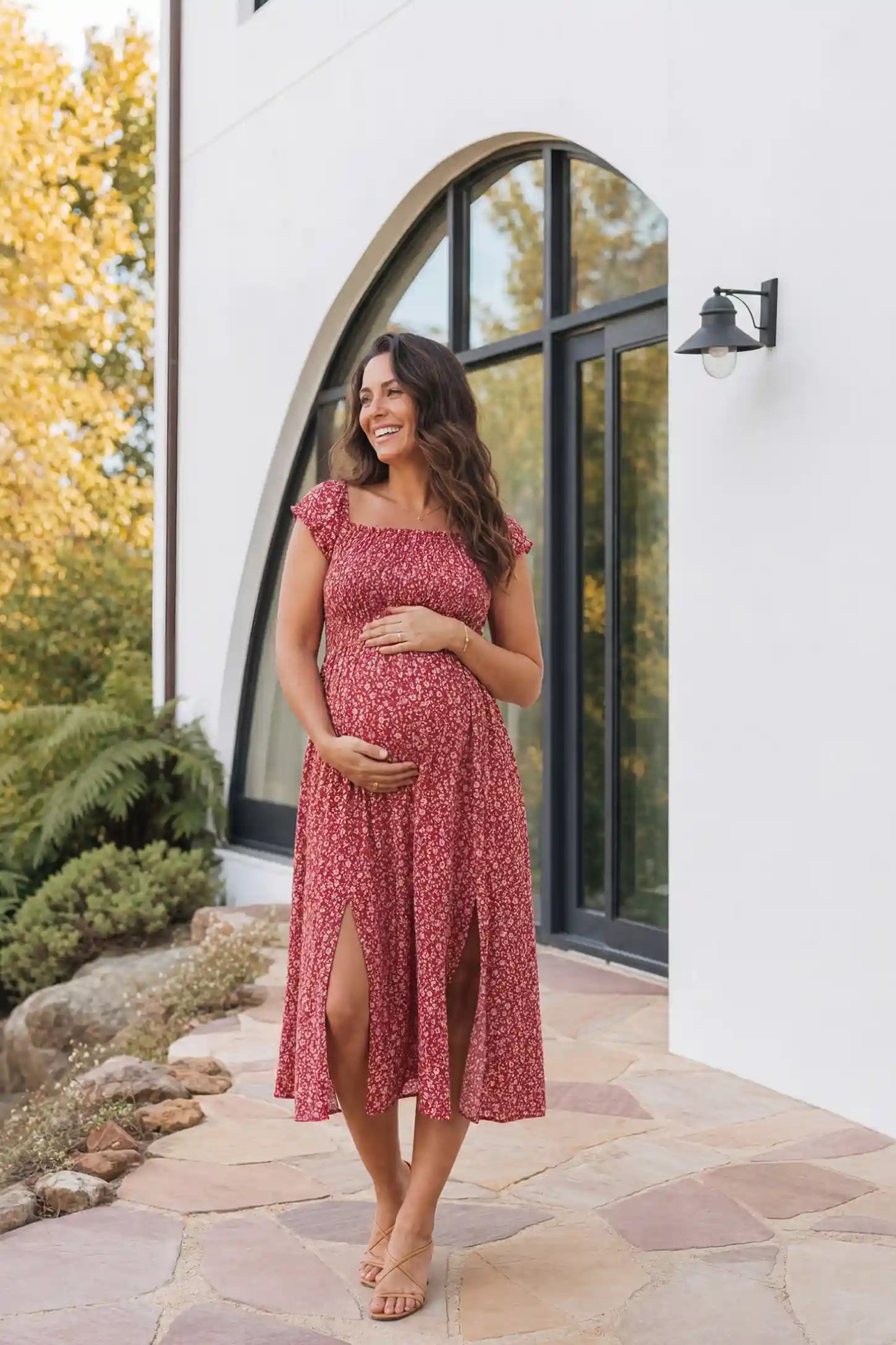 Floral Off-Shoulder Smocked Bodice Maxi Maternity Dress Floral off-shoulder smocked bodice maxi maternity dress in red featuring smocked neckline in front view on a pregnant model