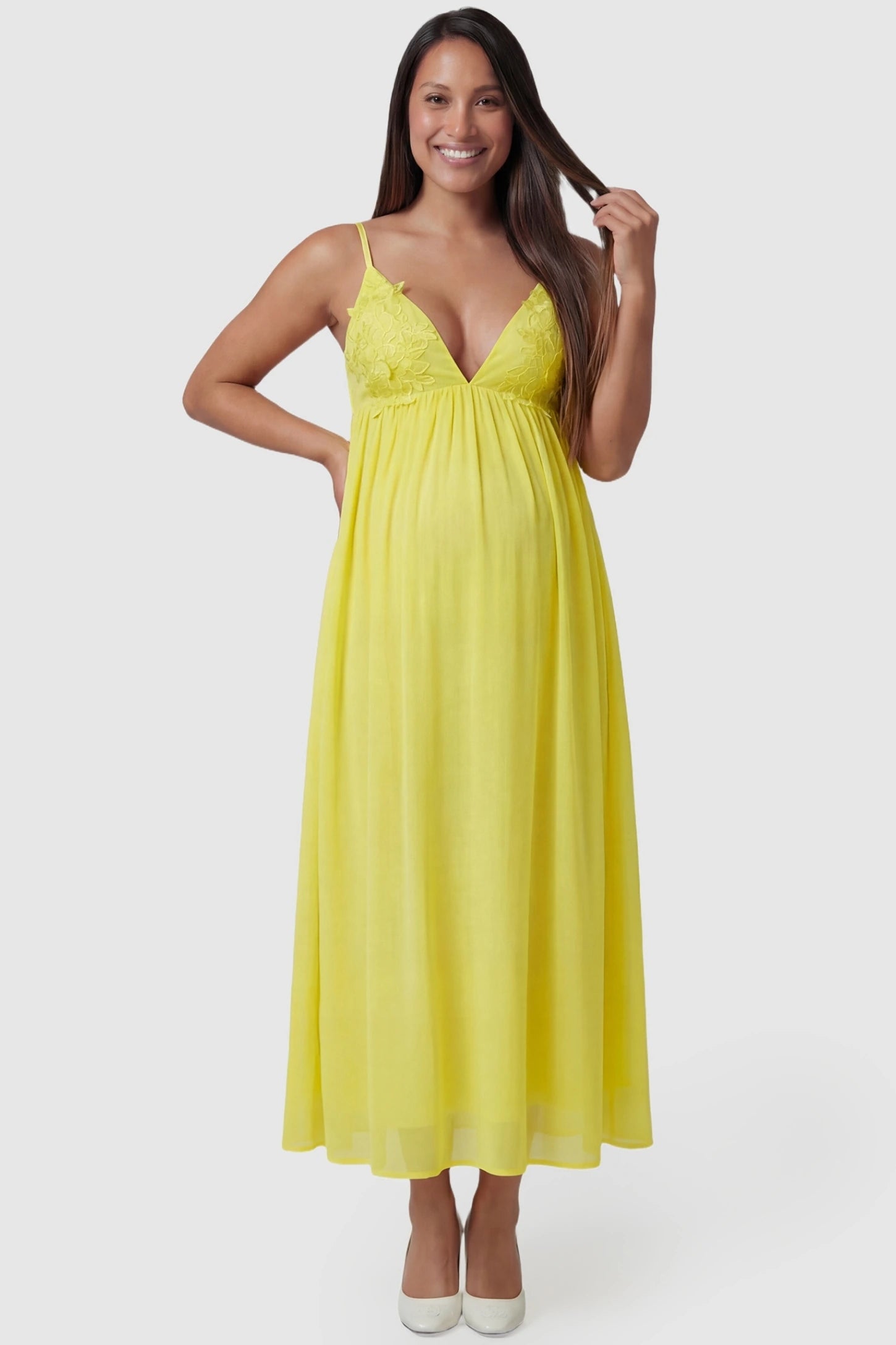 Floral Embroidered Chiffon Maternity Maxi Dress in Yellow featuring a deep V-neck on a pregnant model front view.