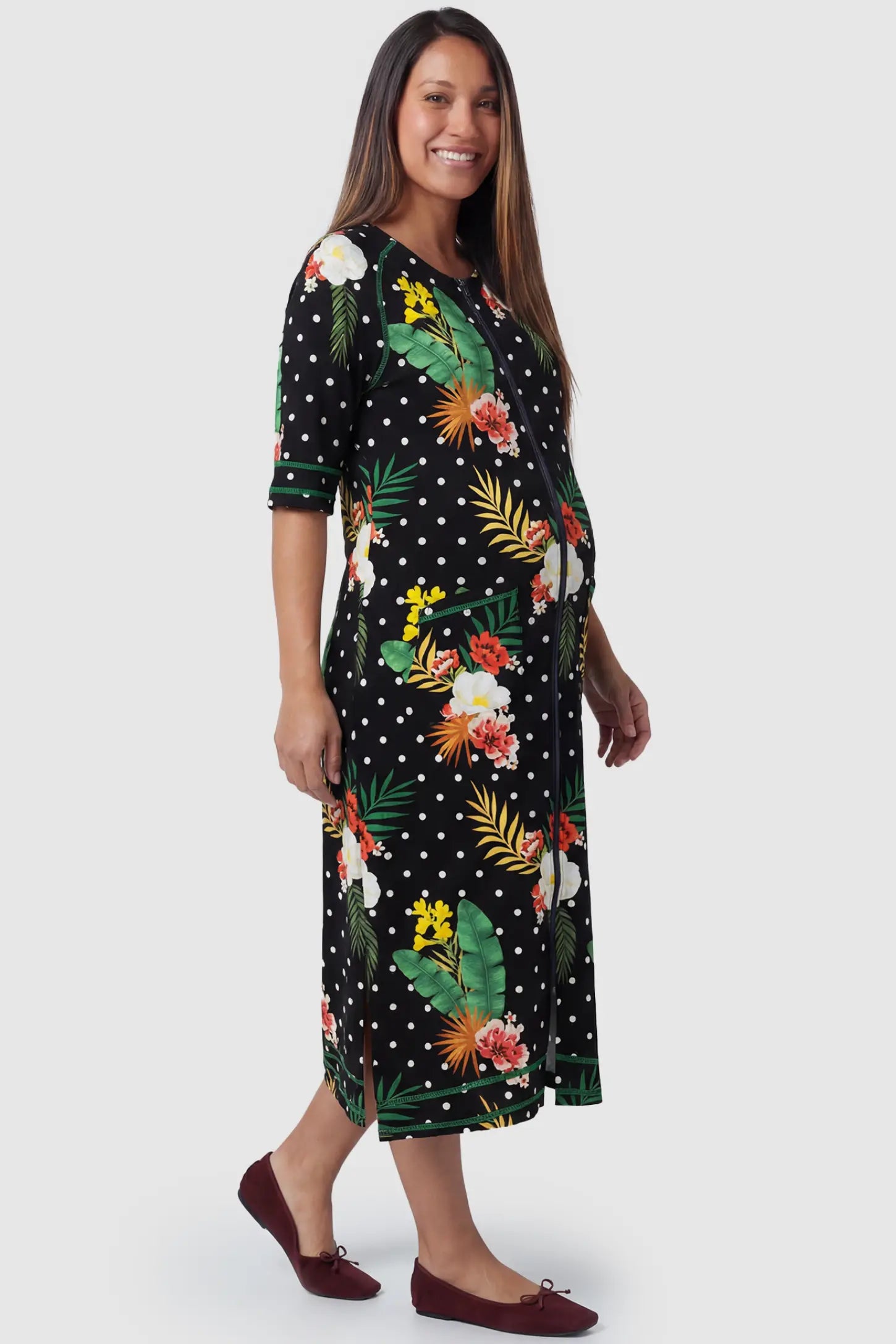 Front-Zip Floral & Polka Dot Maternity & Nursing Midi Lounge Dress  in black with white dots and green floral print featuring full zipper closure and A-line silhouette on pregnant model.