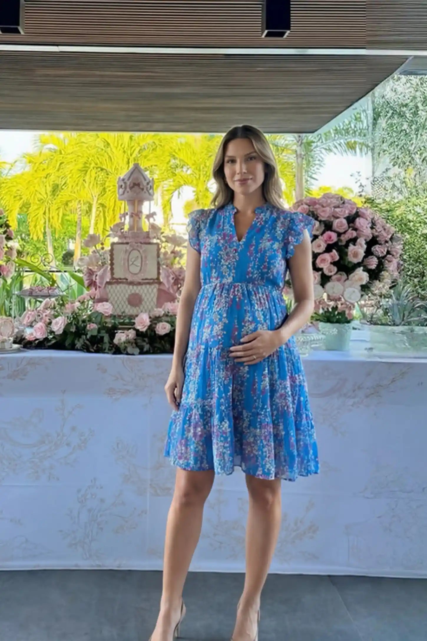 Floral V-Neck A-Line Short Maternity Dress Floral V-neck A-line short maternity dress in blue with airy chiffon flow, on editorial lifestyle model