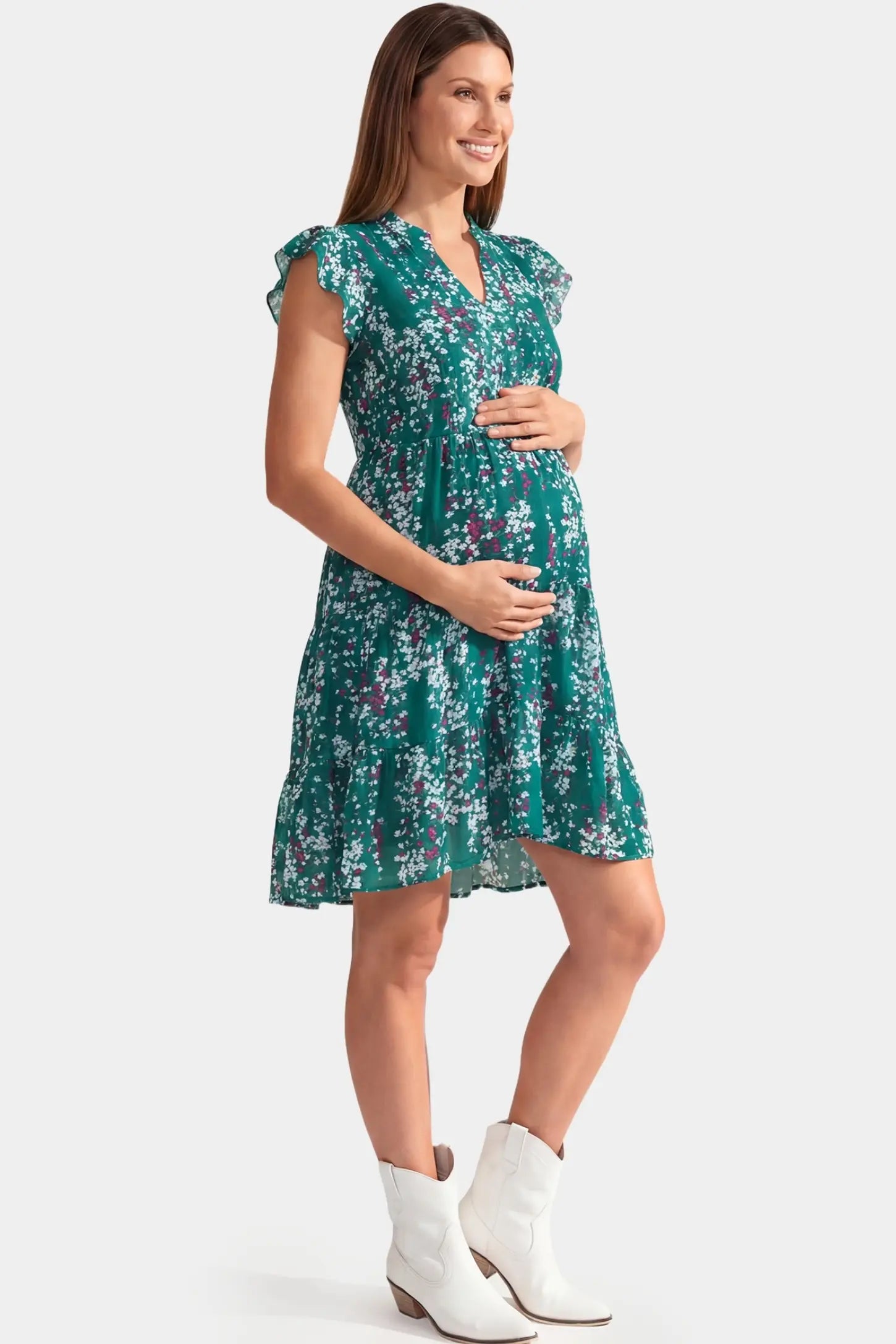 Floral V-Neck A-Line Short Maternity Dress Floral V-Neck A-Line Short Maternity Dress in green featuring flutter sleeves in full body side view on a pregnant model